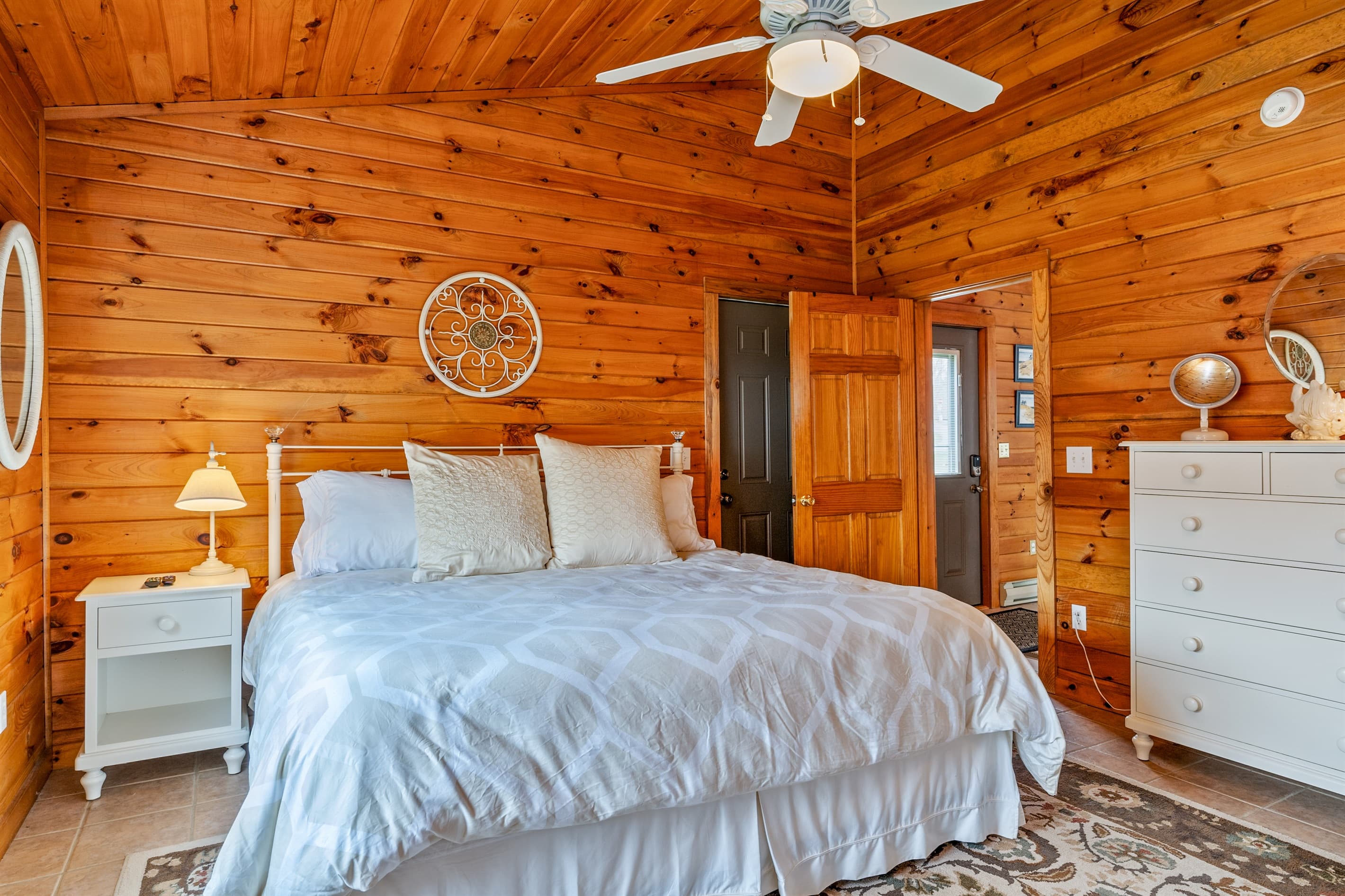 Wood-paneled bedroom with ample storage