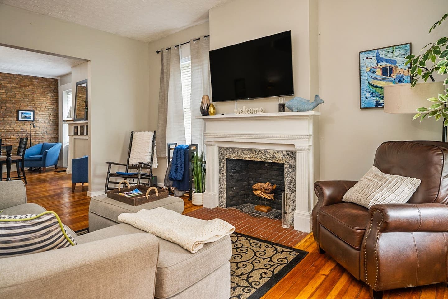 Living room with fireplace and wall-mounted television