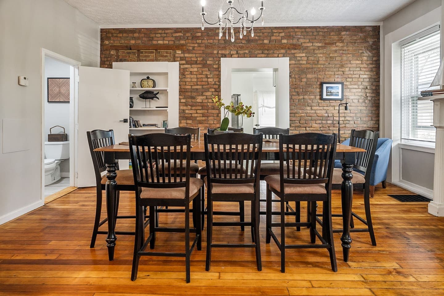 Dining room with exposed brick accent wall