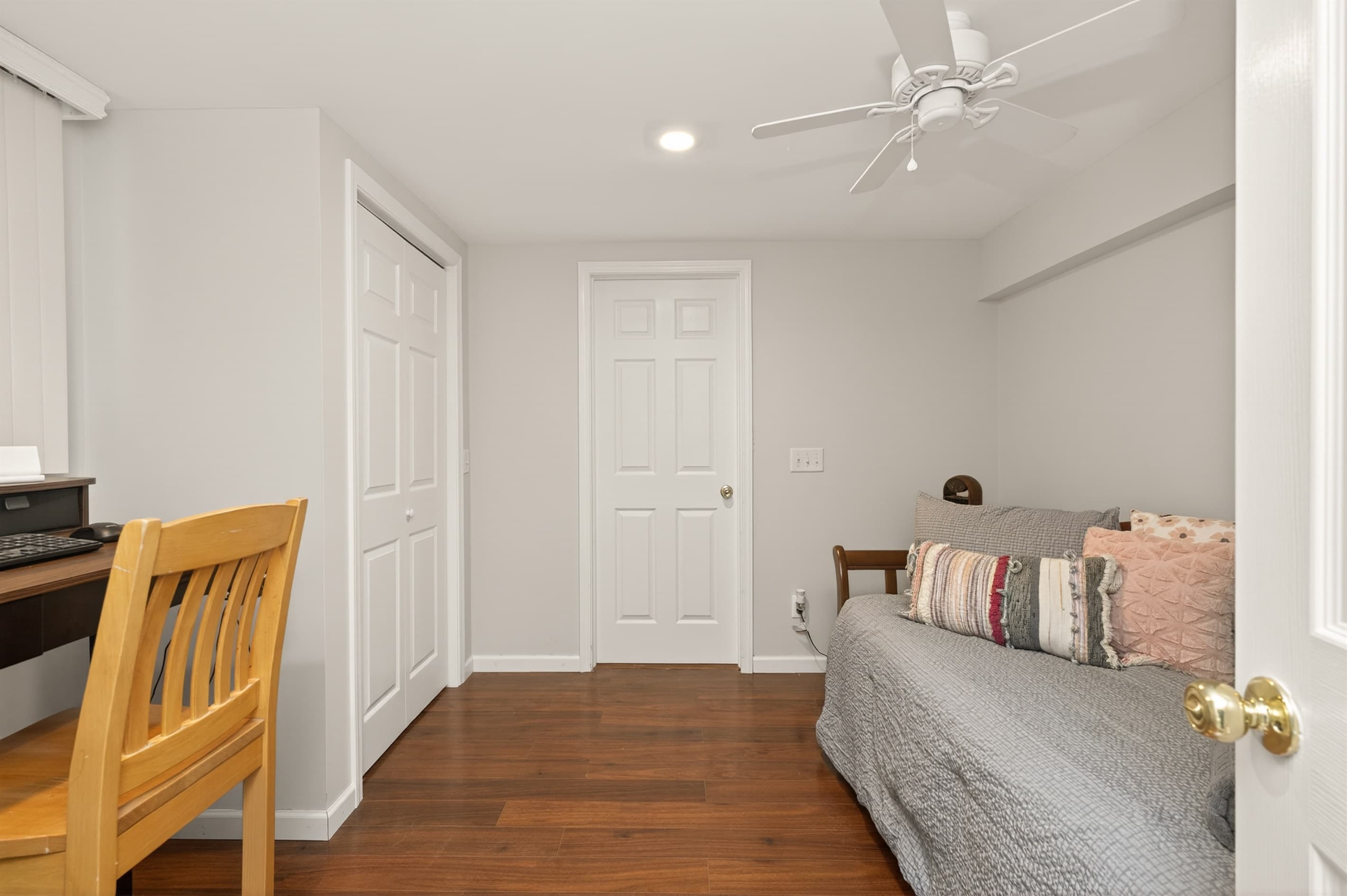 Bedroom with upholstered bed and adjoining doorway