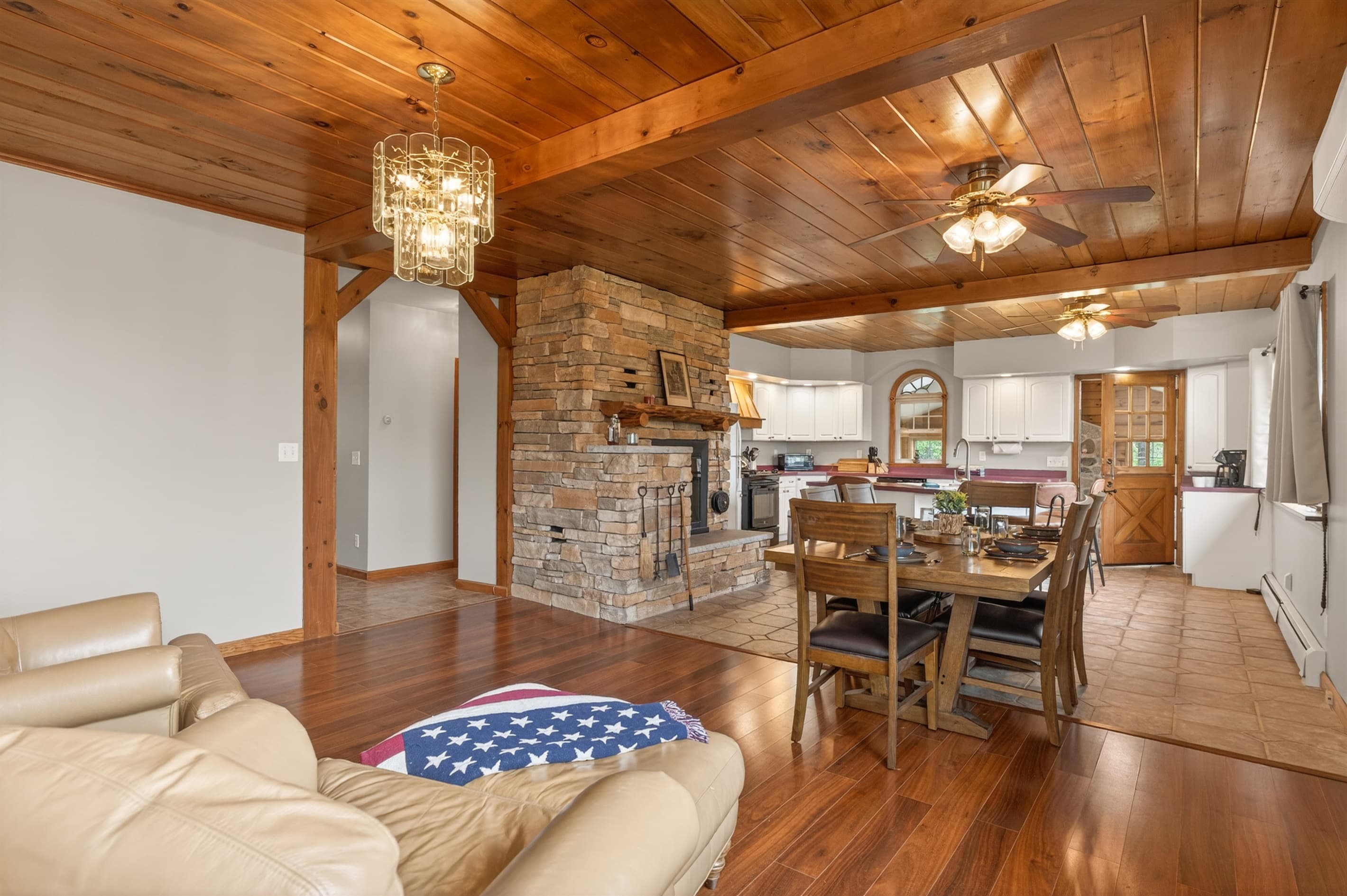 Open living space centered around stone fireplace