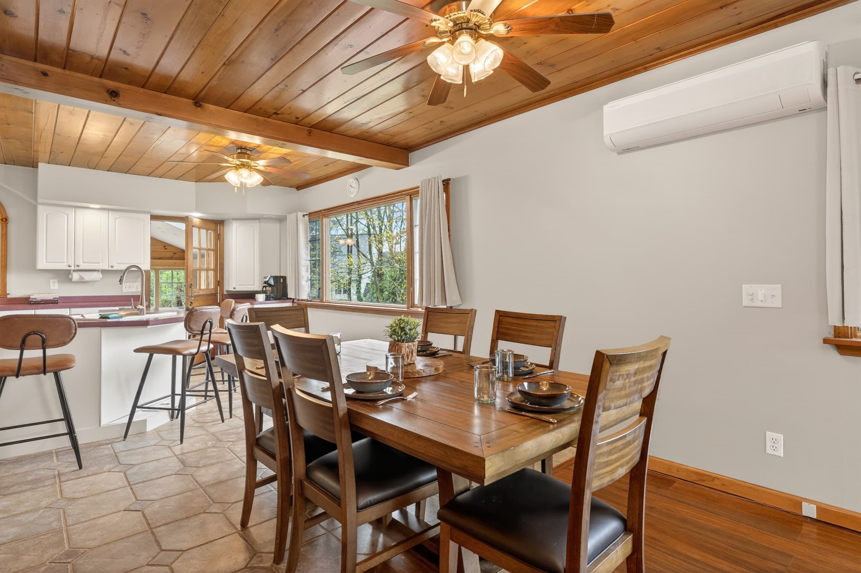 Dining table beneath wooden ceiling beams