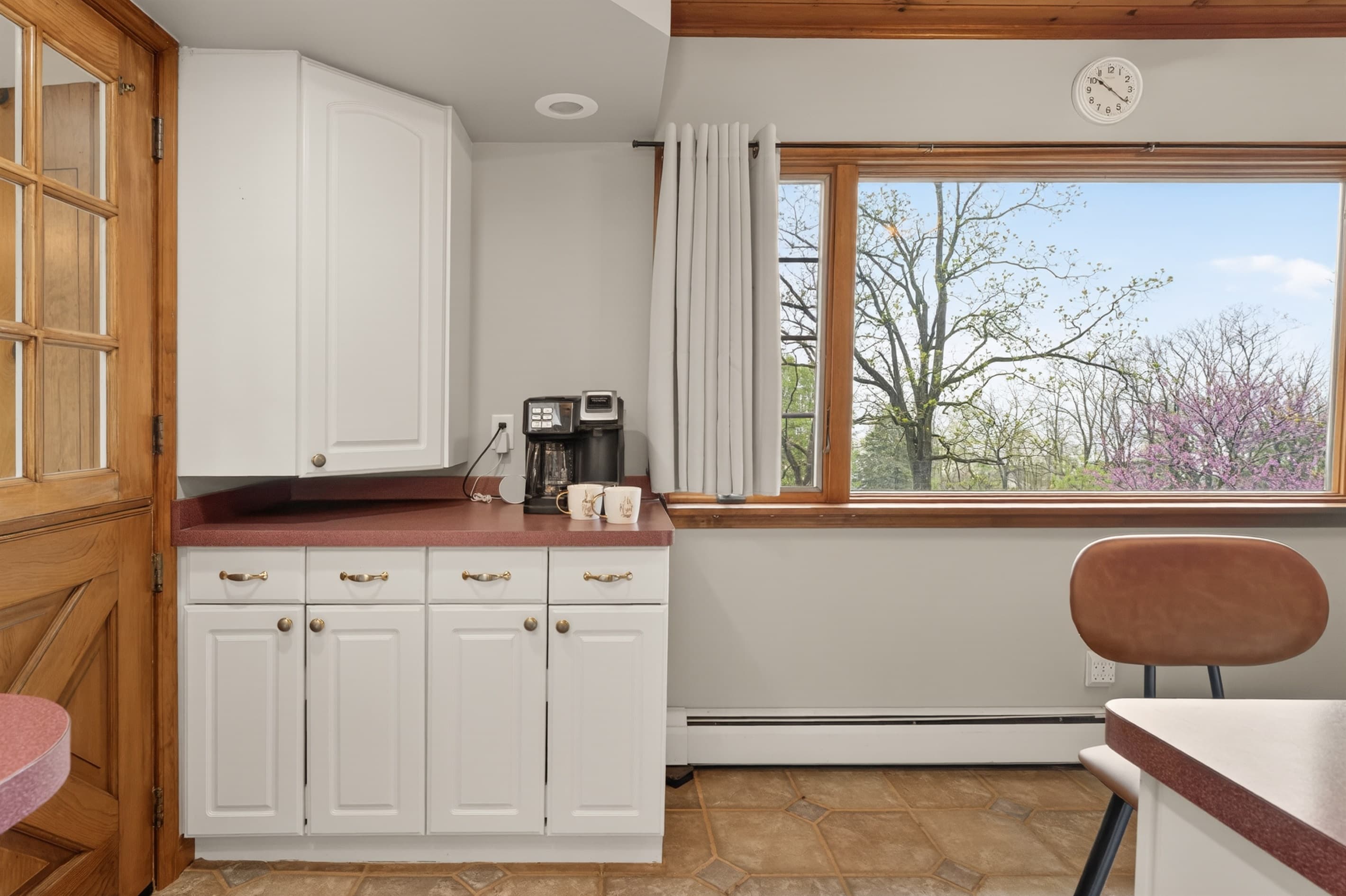 Counter and cabinets beside large windows