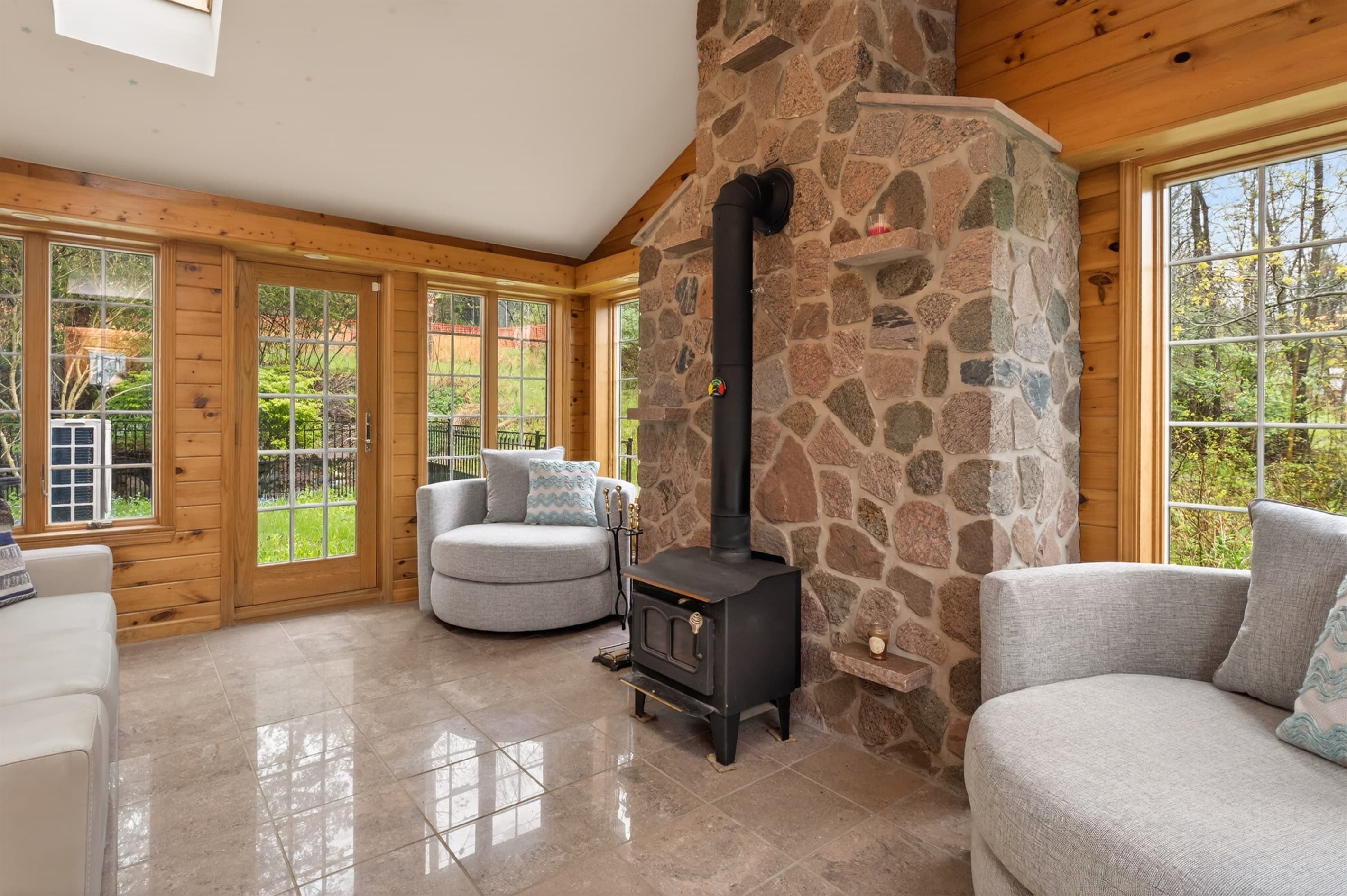 Living room with fireplace and stone wall 