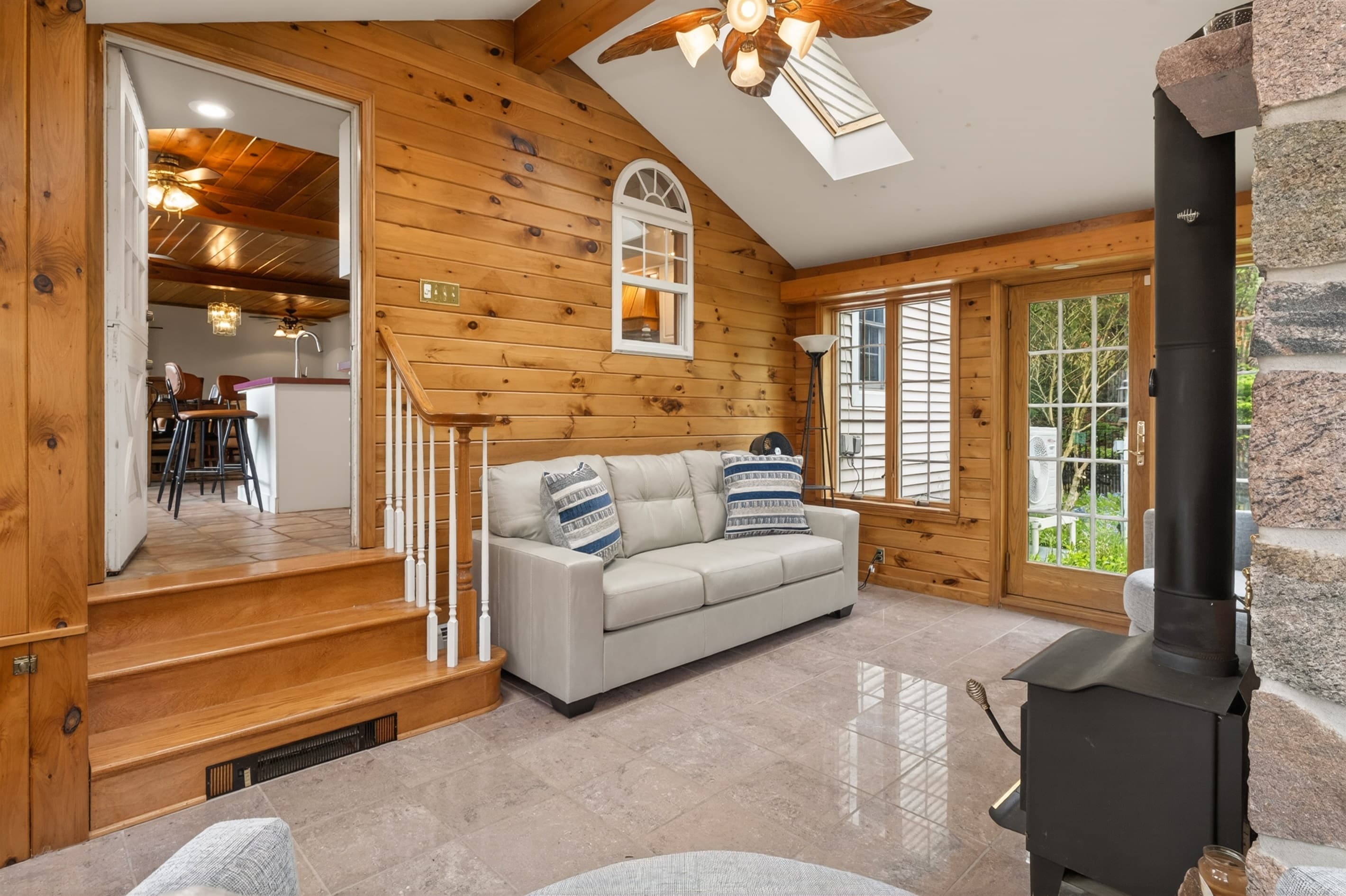 Wood-paneled sitting room with sofa