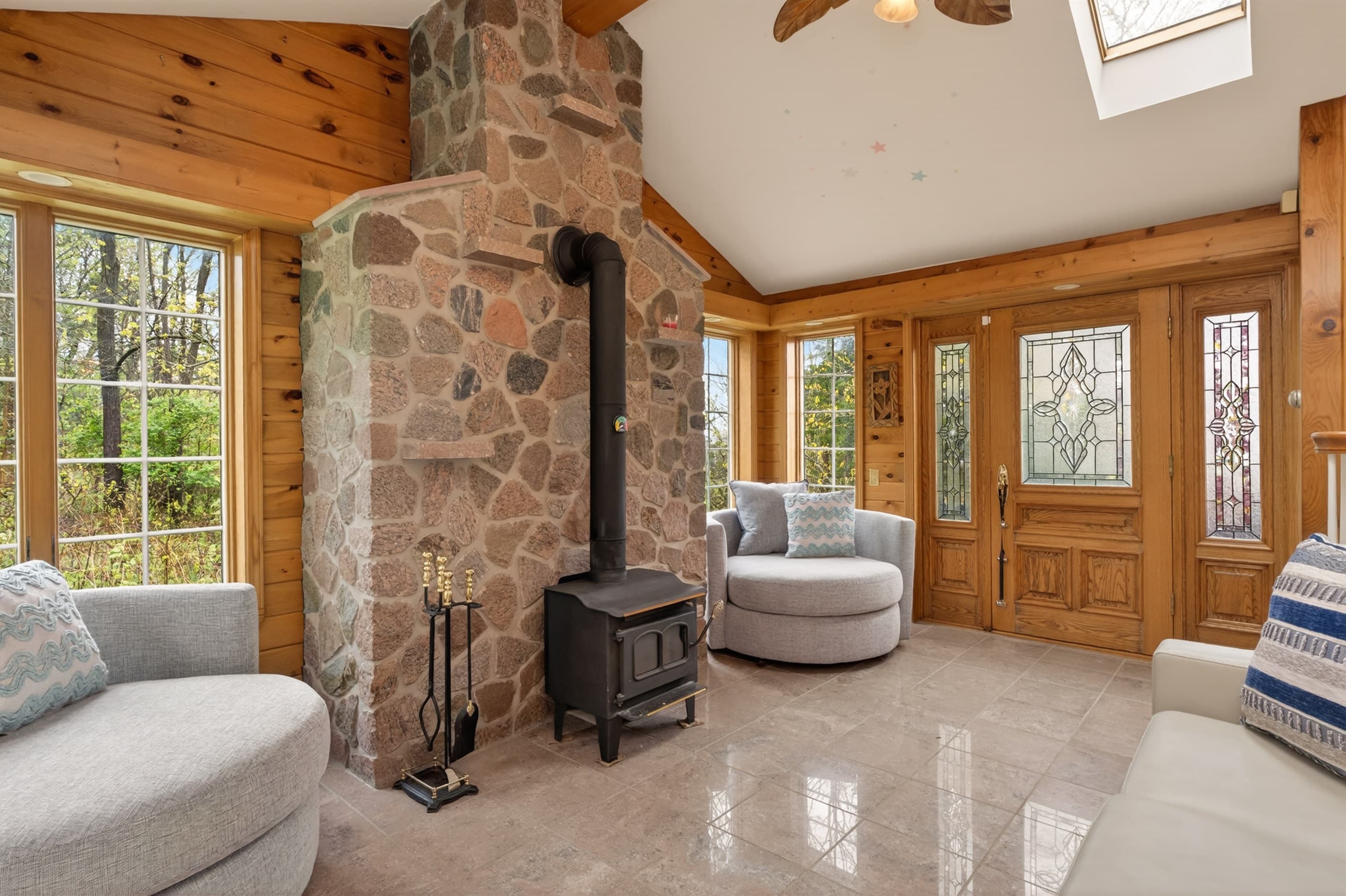 Steel fireplace against a stone accent wall 