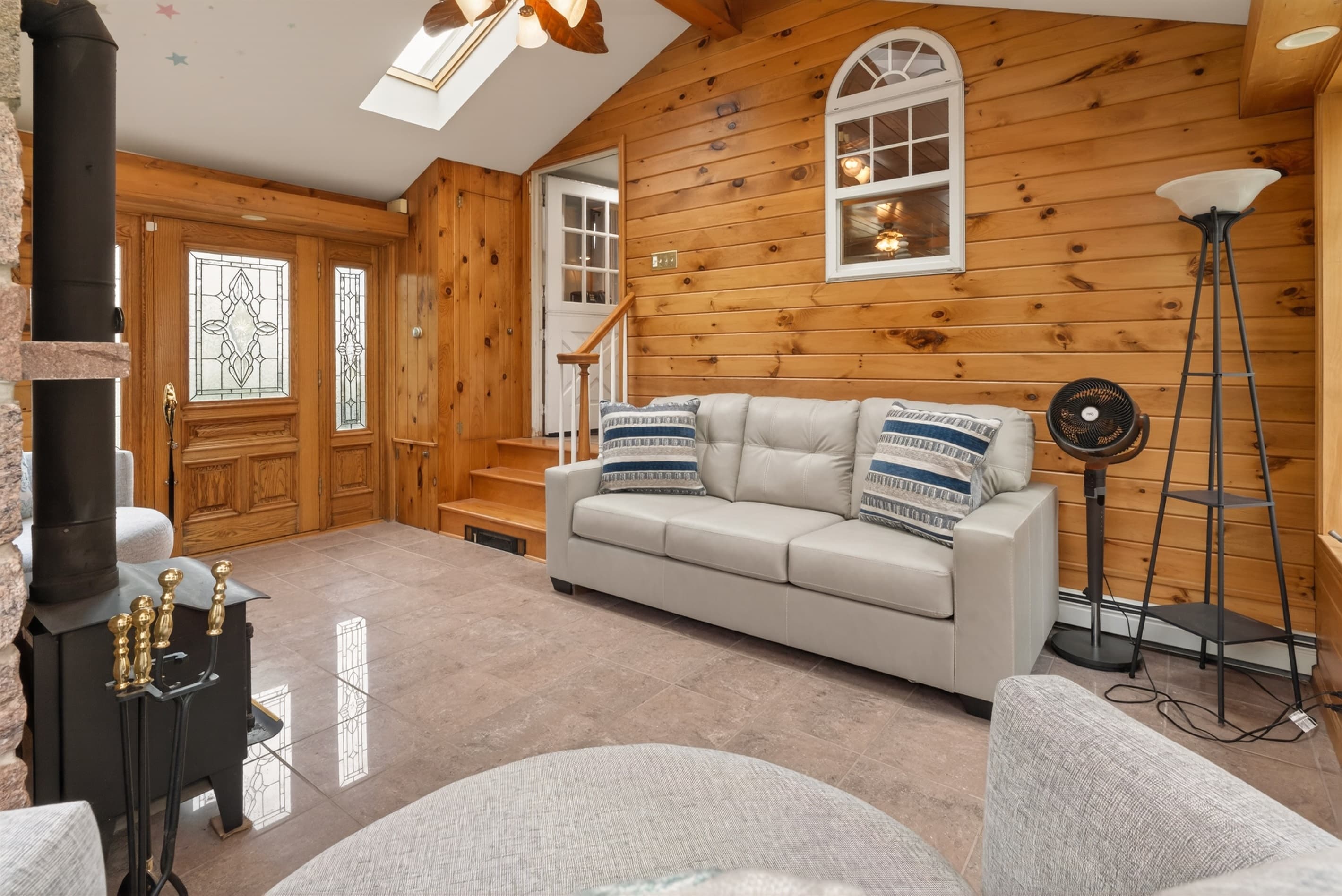 Window-lined sitting room with wooden cabinet