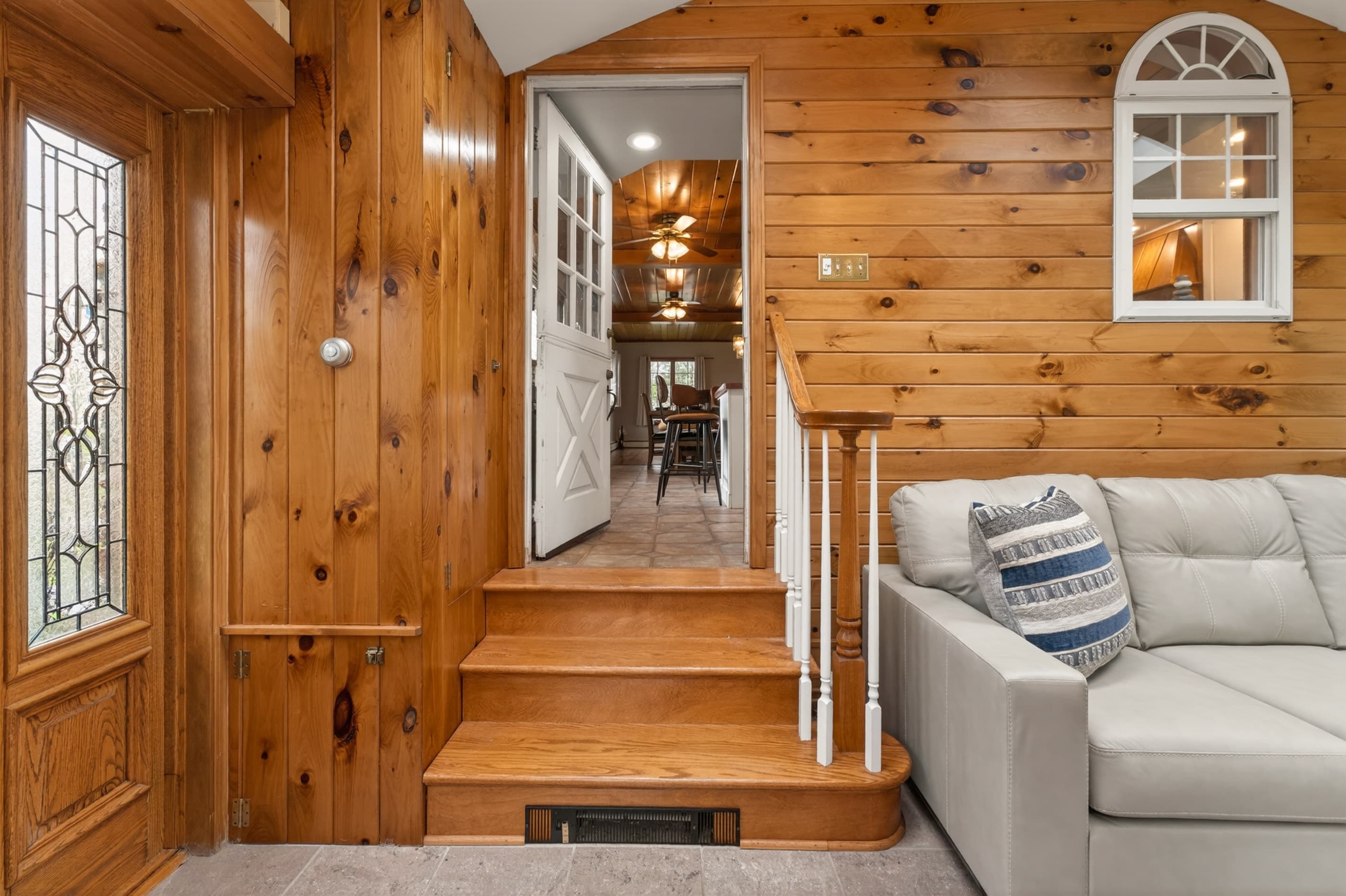 Wood-paneled lounge viewed through wide doorway