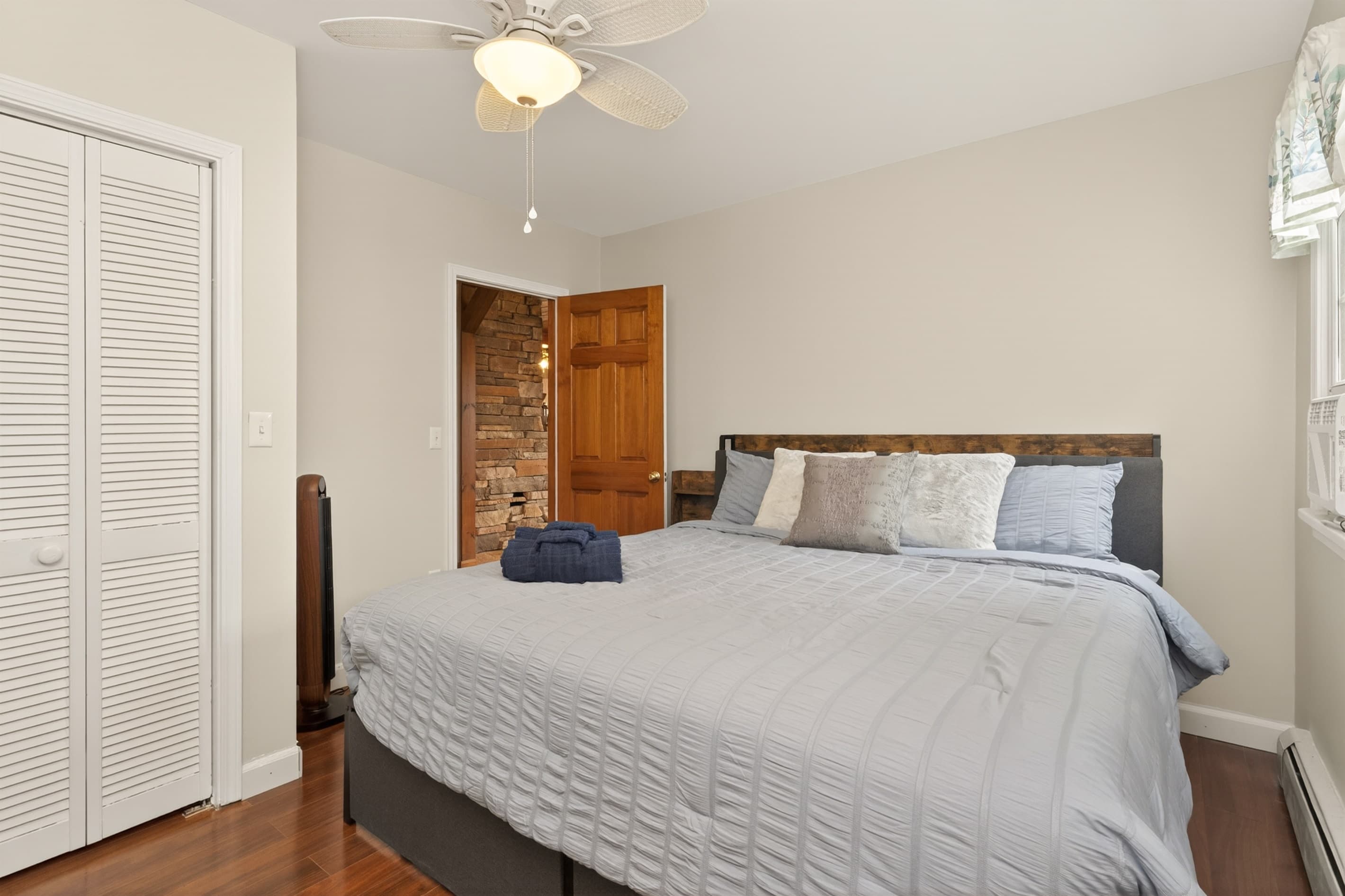 Bedroom with wooden headboard and dresser