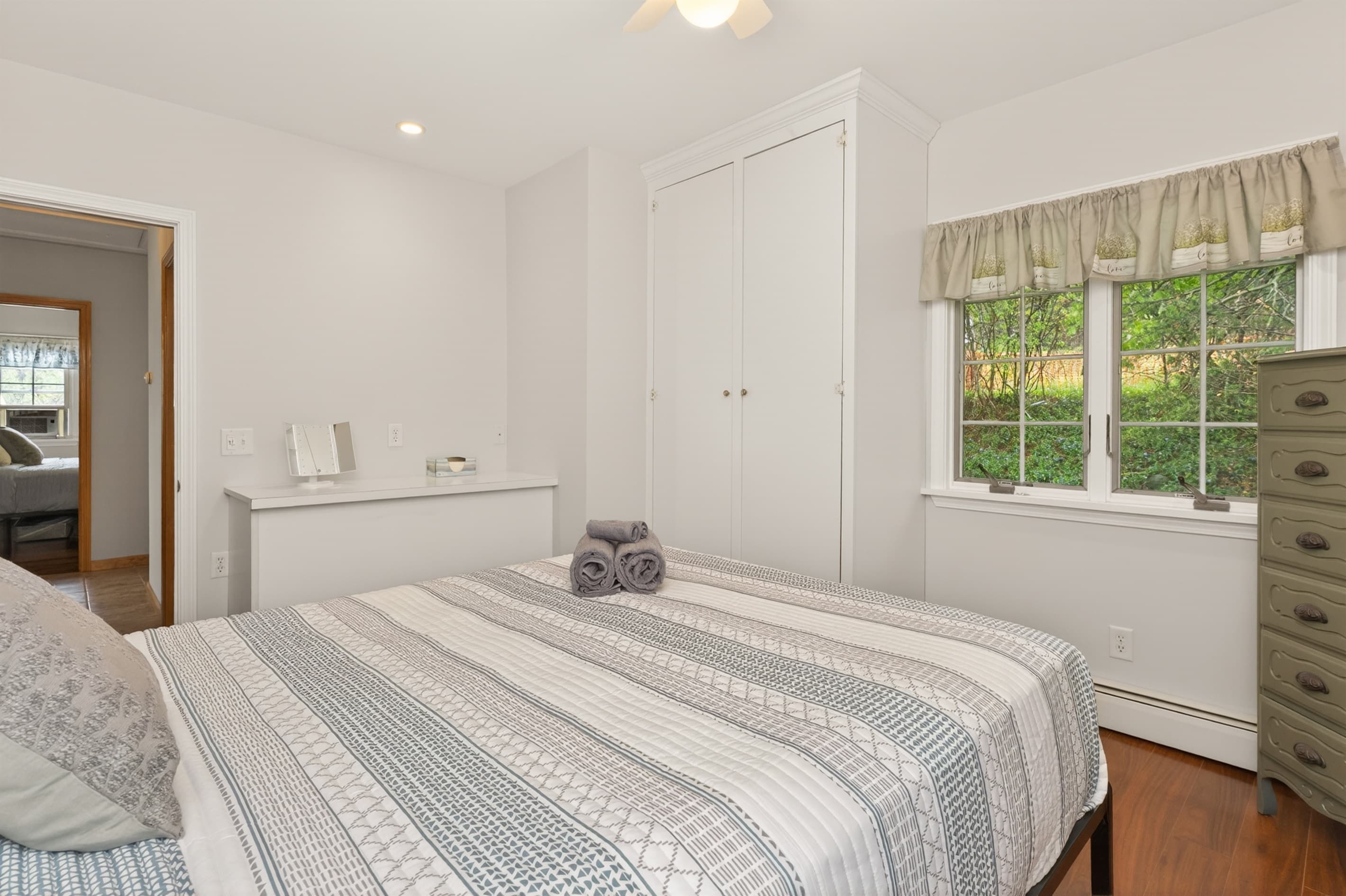 Bedroom with dresser beside the window