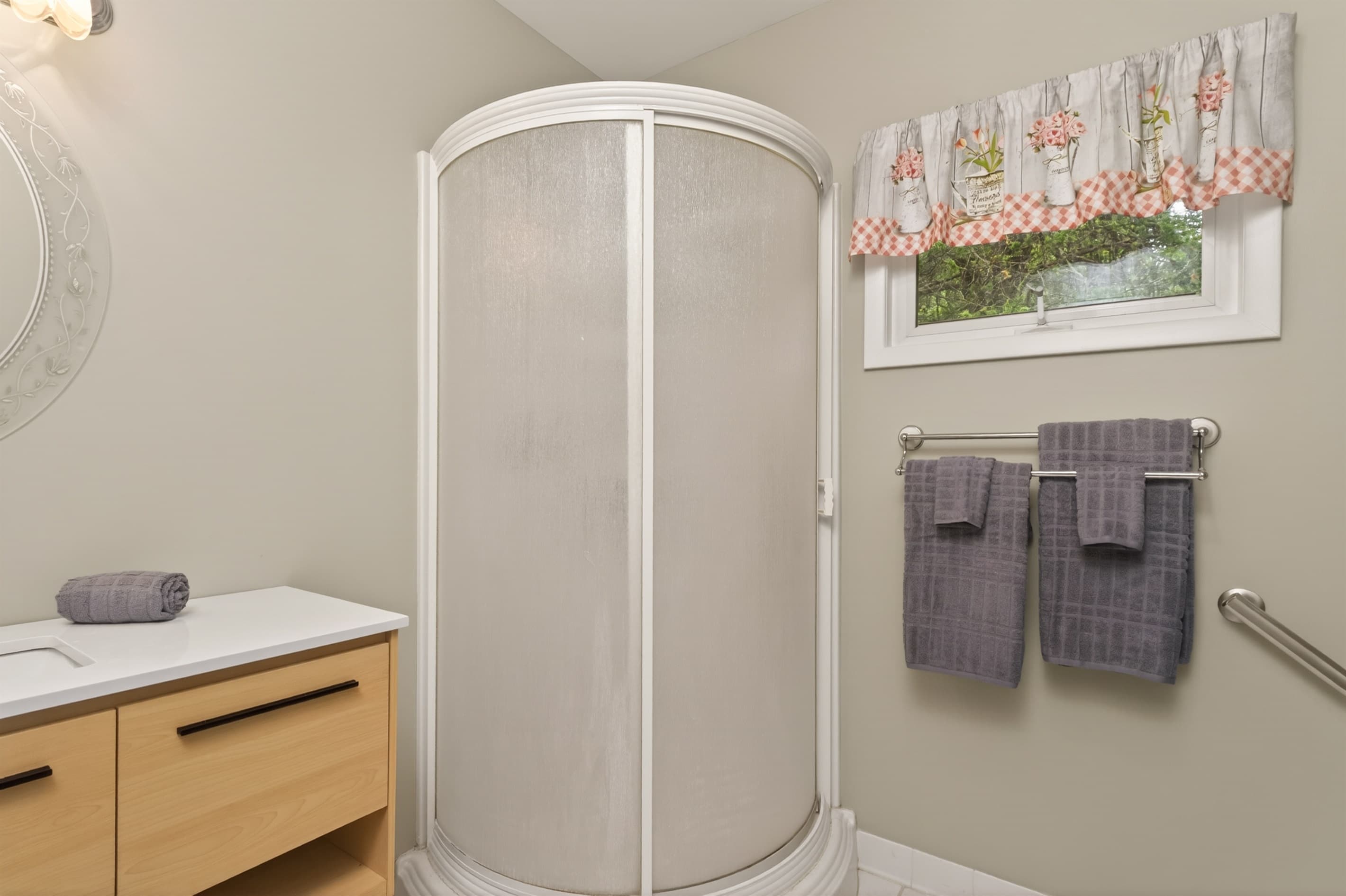 Bathroom with curved glass shower enclosure