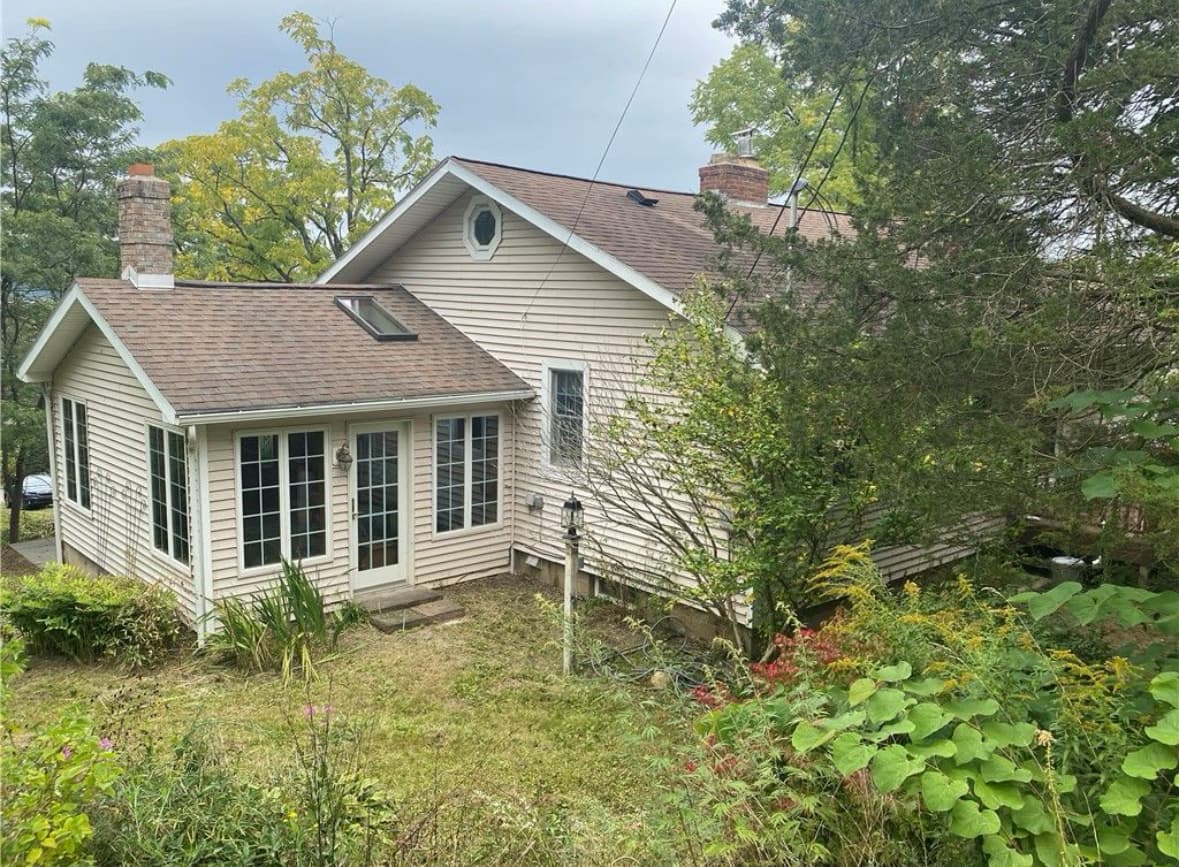Home exterior surrounded by mature landscaping