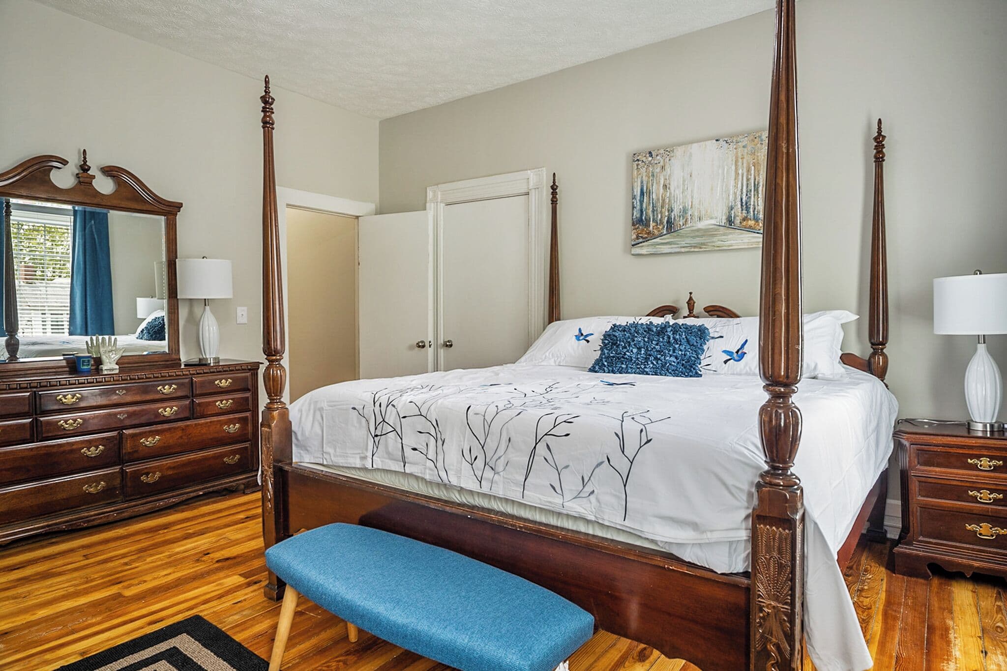 Four-poster bedroom with antique-style furnishings