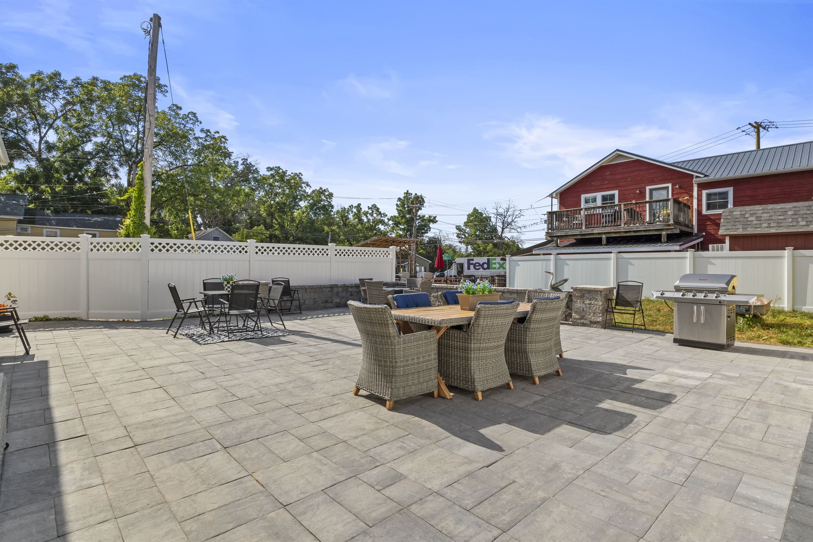 Fenced courtyard with multiple seating areas