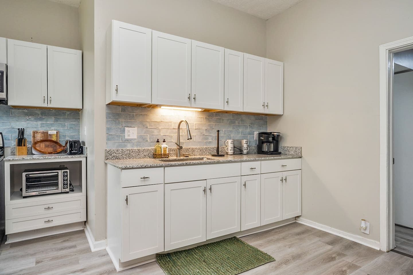 Unit 42 kitchenette with white cabinetry