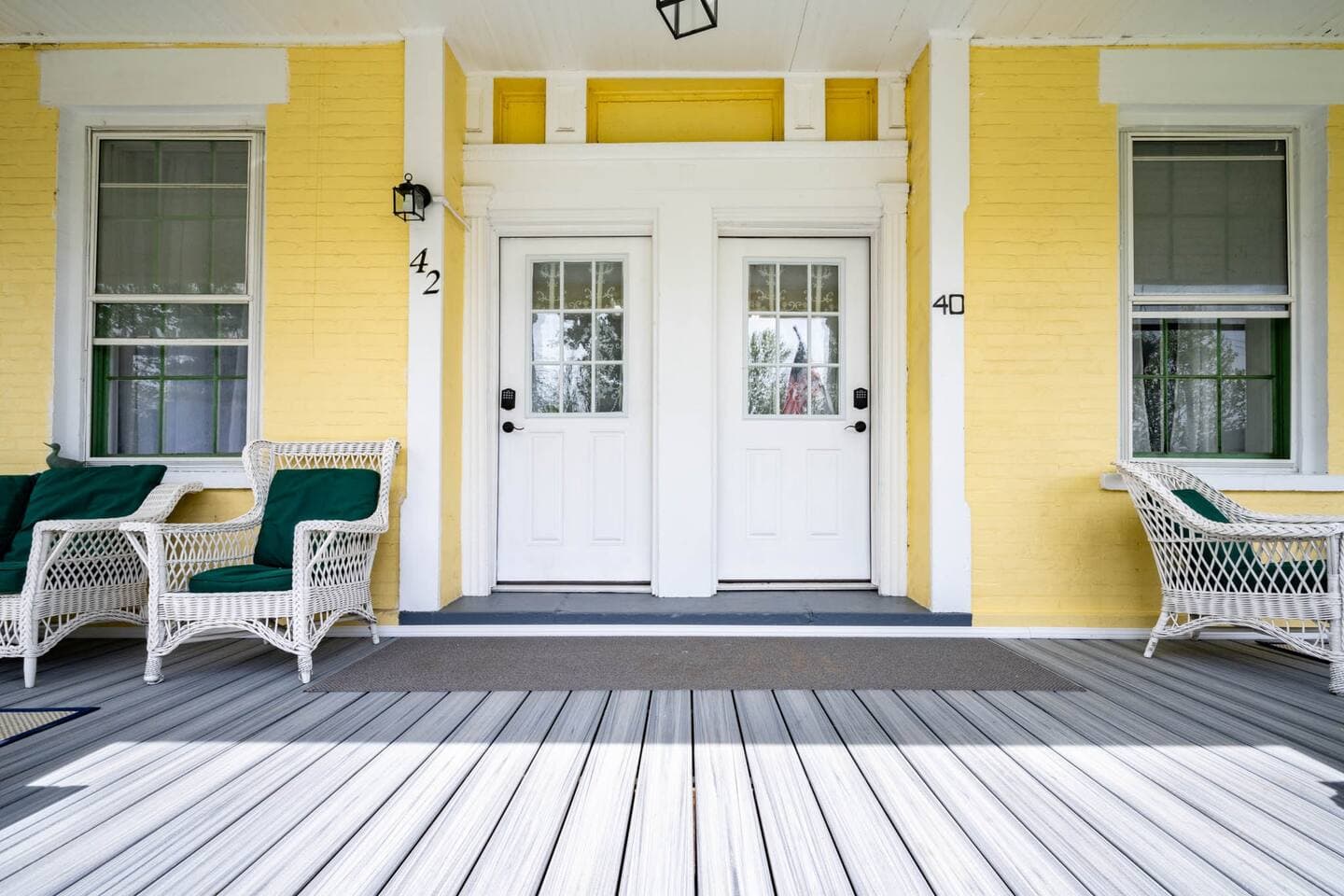 Main entrance with twin doors and porch seating