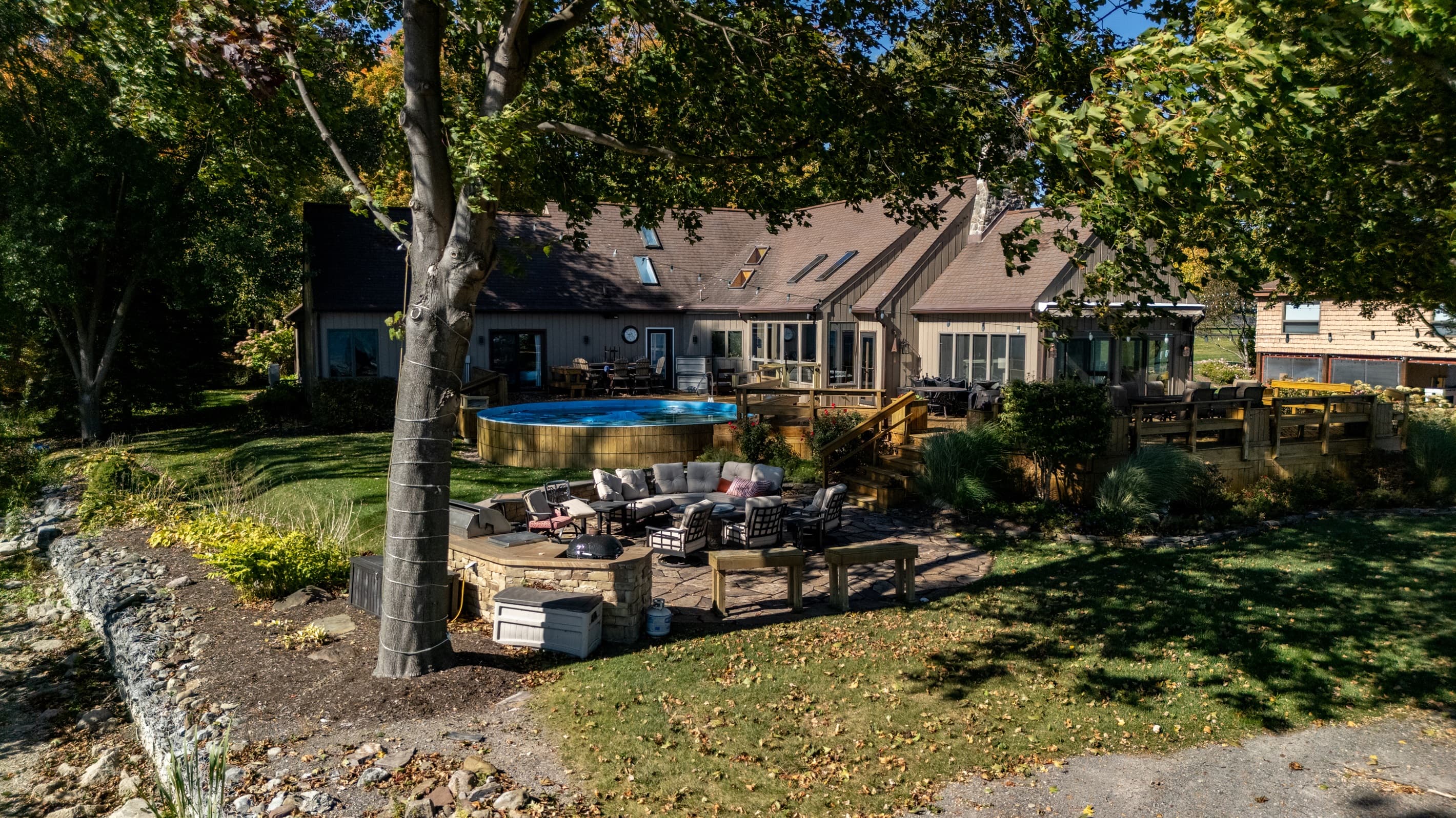 Lakeside home with stone patio seating