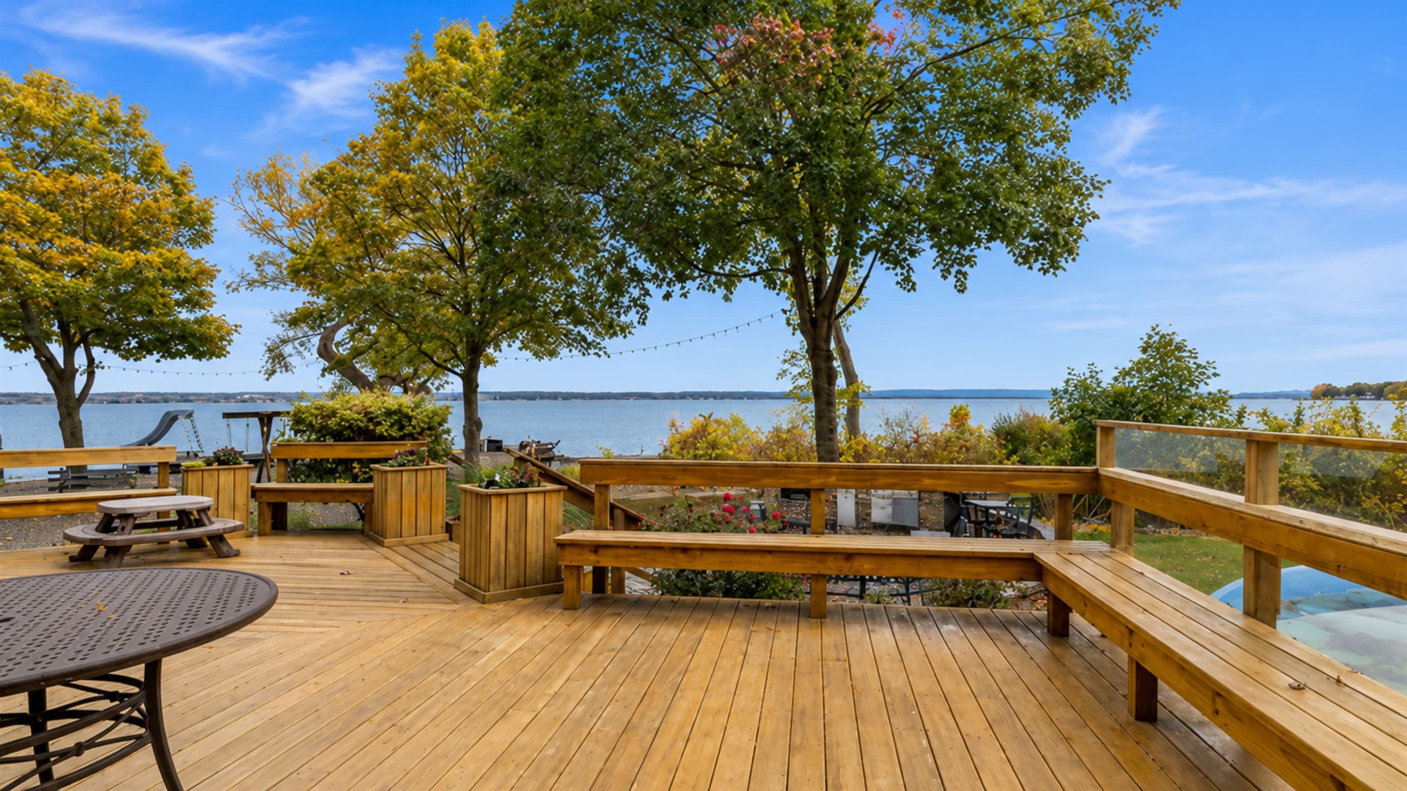 Expansive waterfront deck with multiple seating areas