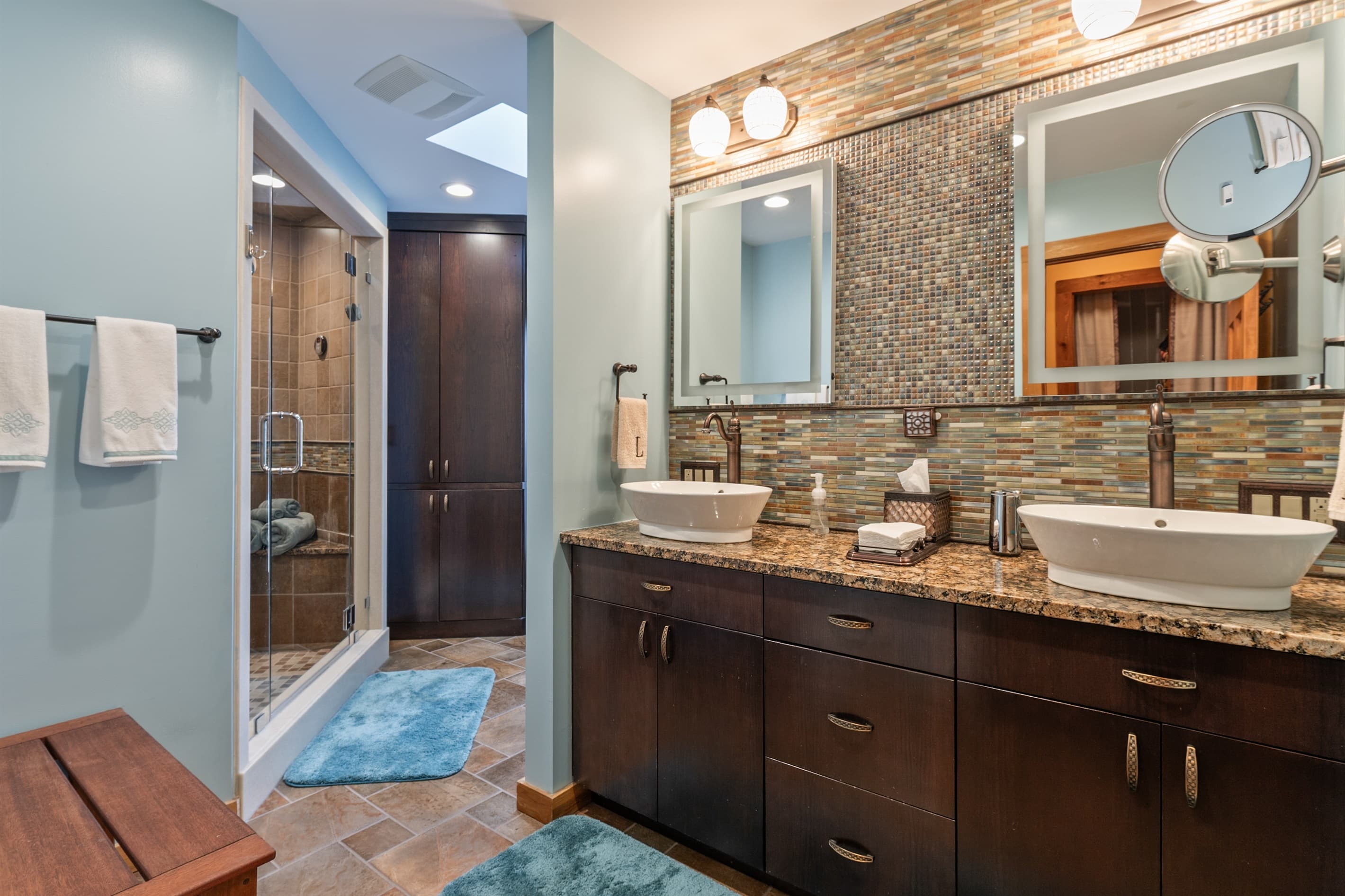 Bathroom with double vanity and stone counters