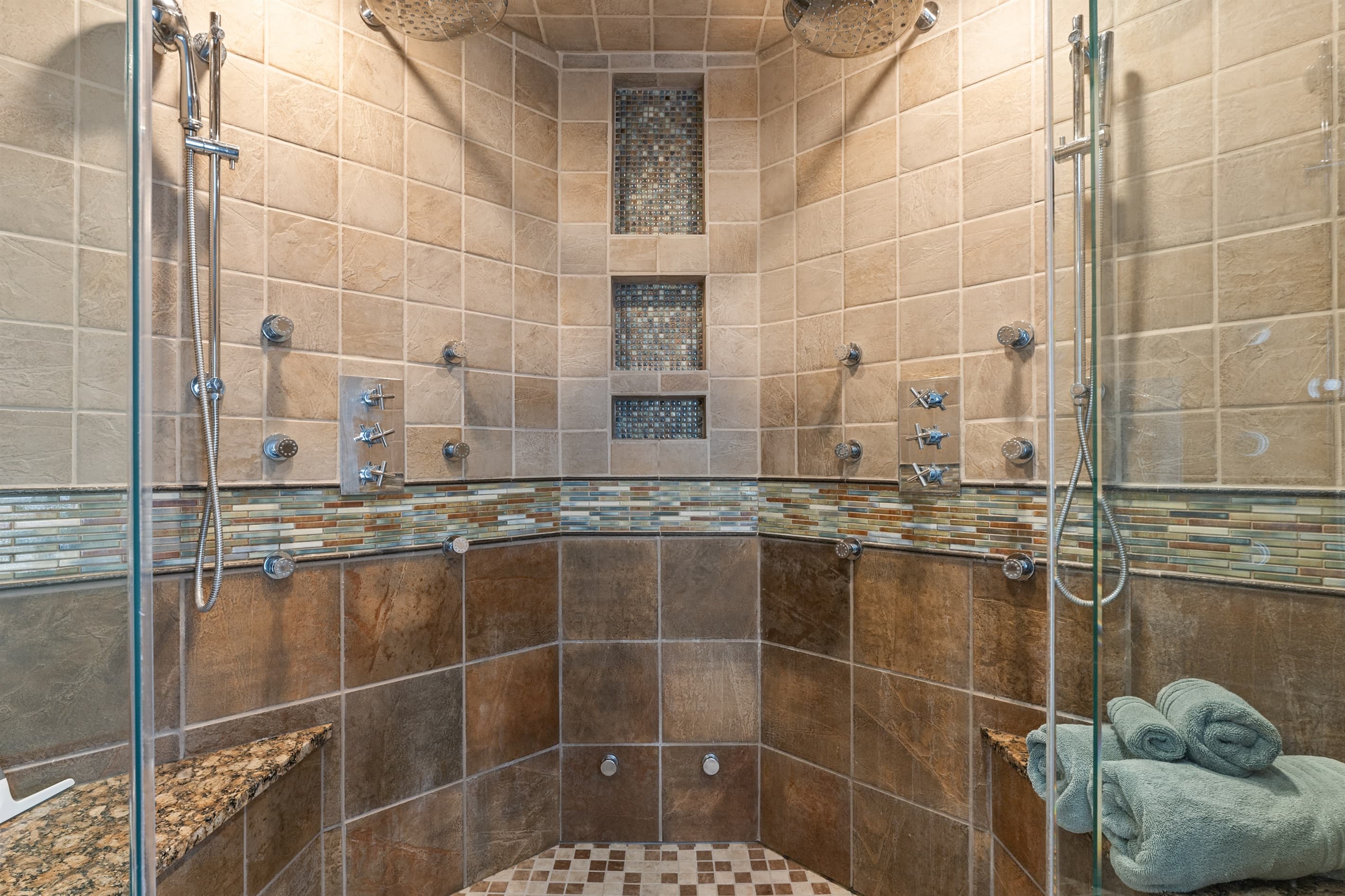 Walk-in shower with tile walls and body jets