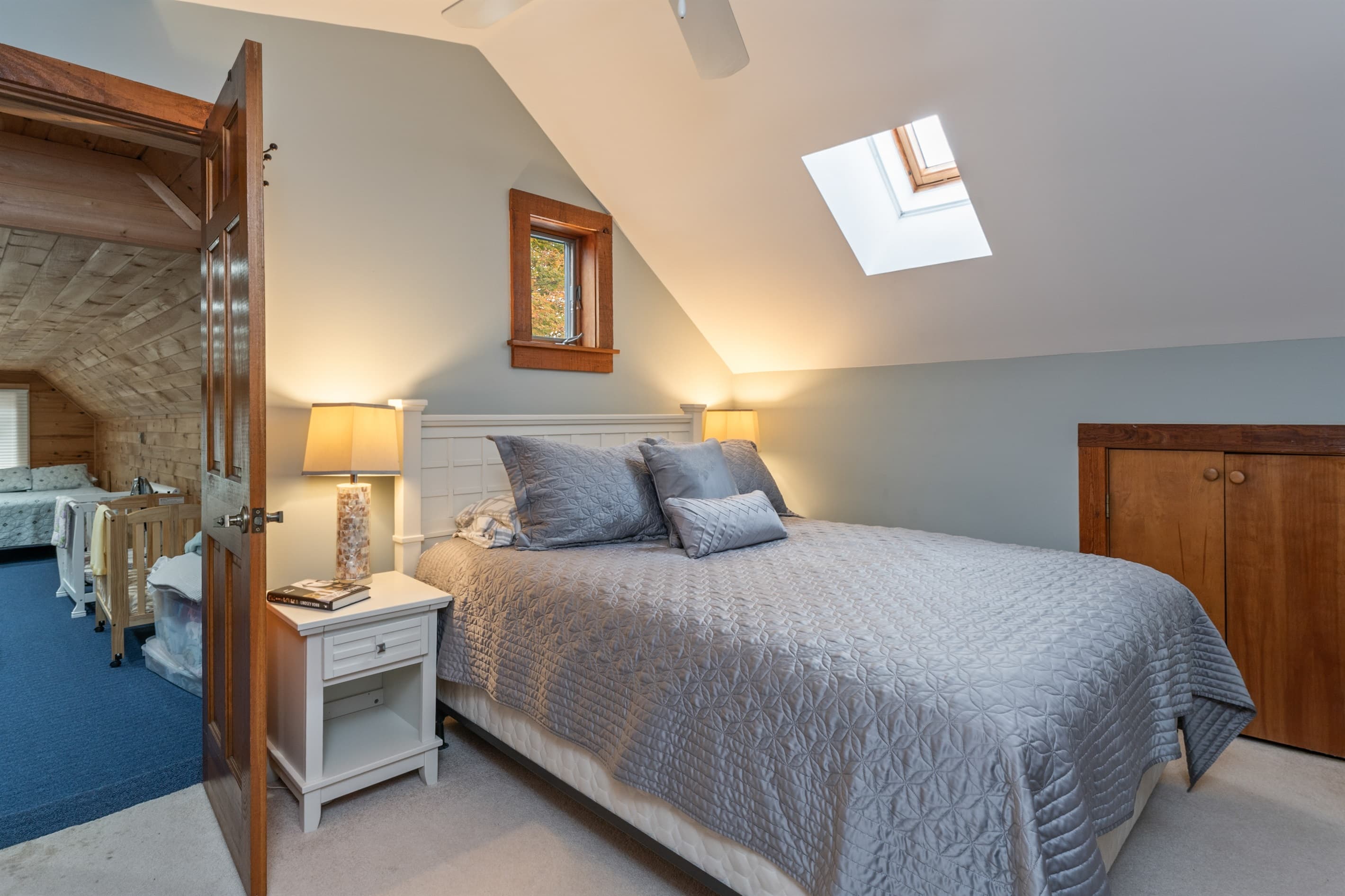 Upper-level bedroom beneath sloped ceilings