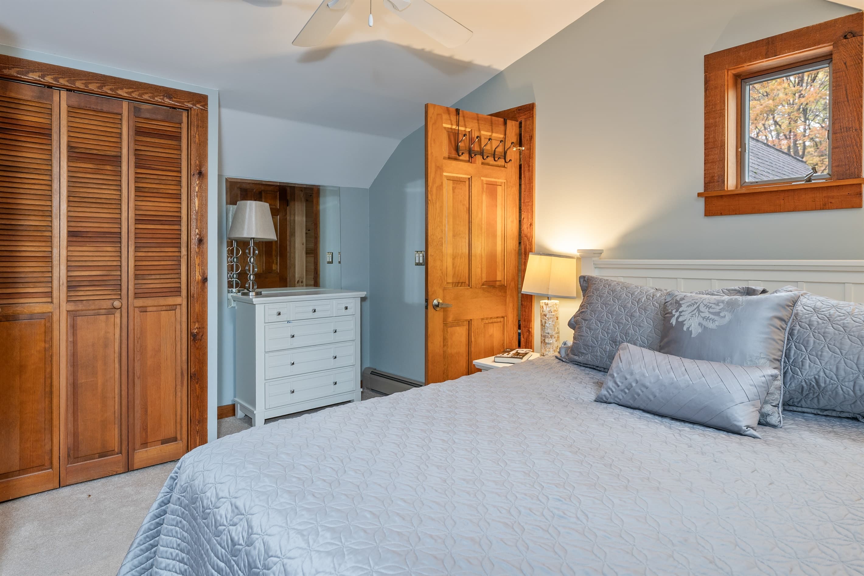 Bedroom with ample storage and wood accents