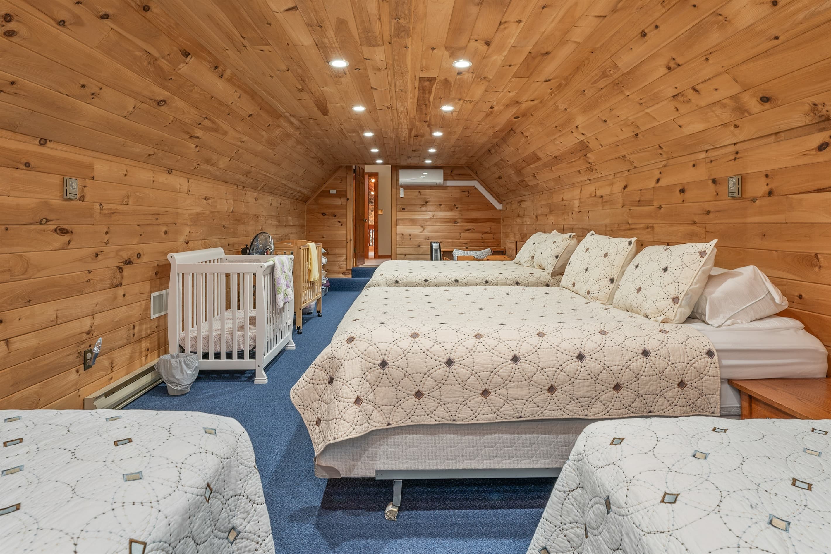 Wood-paneled bunk room with multiple beds