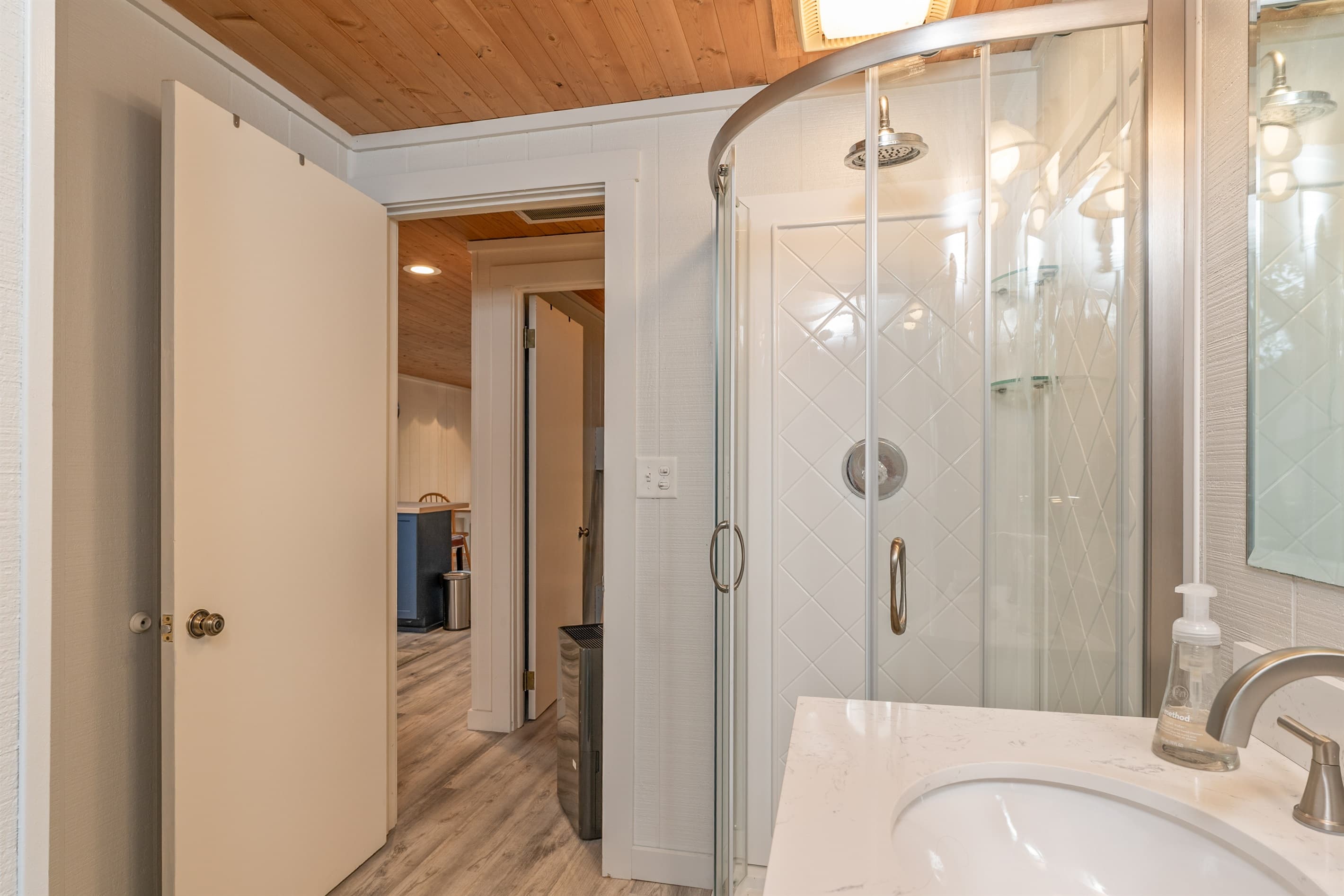 Glass-enclosed shower with built-in seating