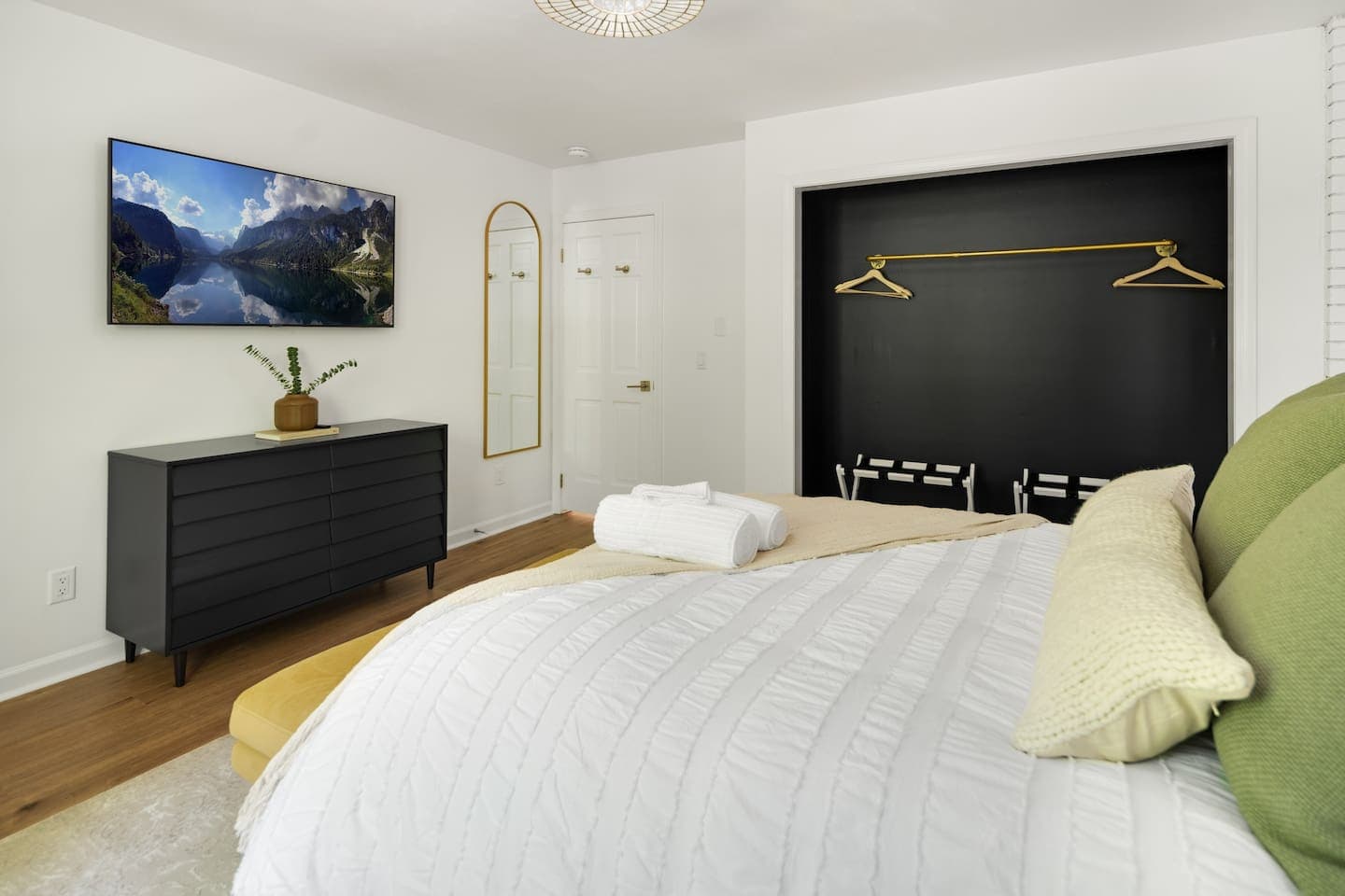 Bedroom with queen bed and art 