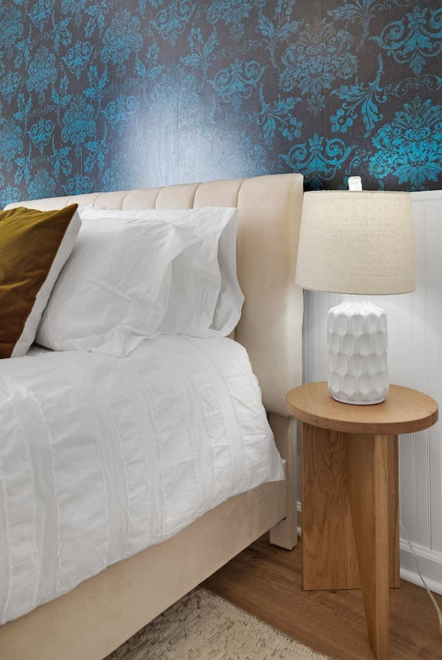 Bedside lighting and patterned accent wall