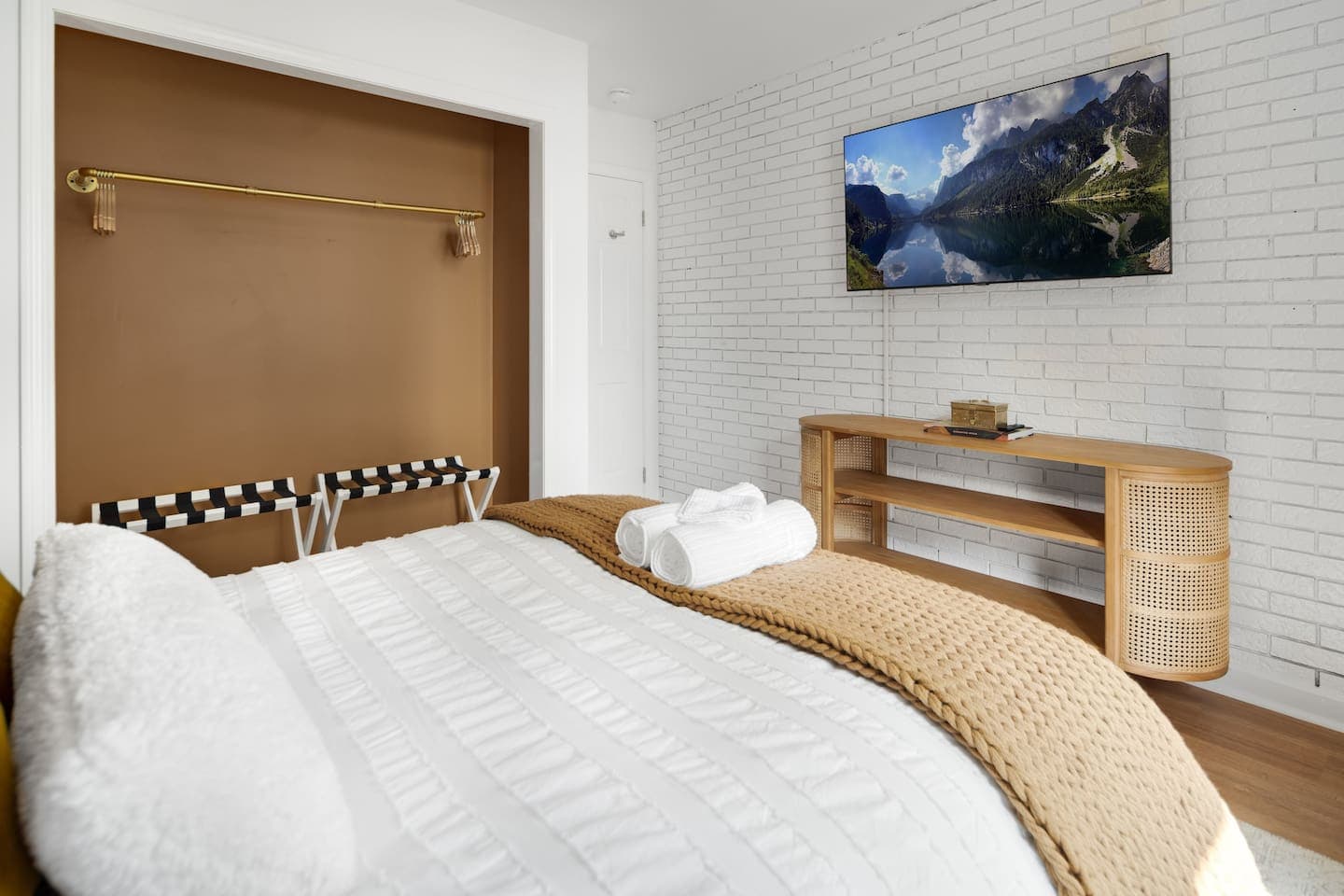 Bedroom with wall art and exposed hanging closet