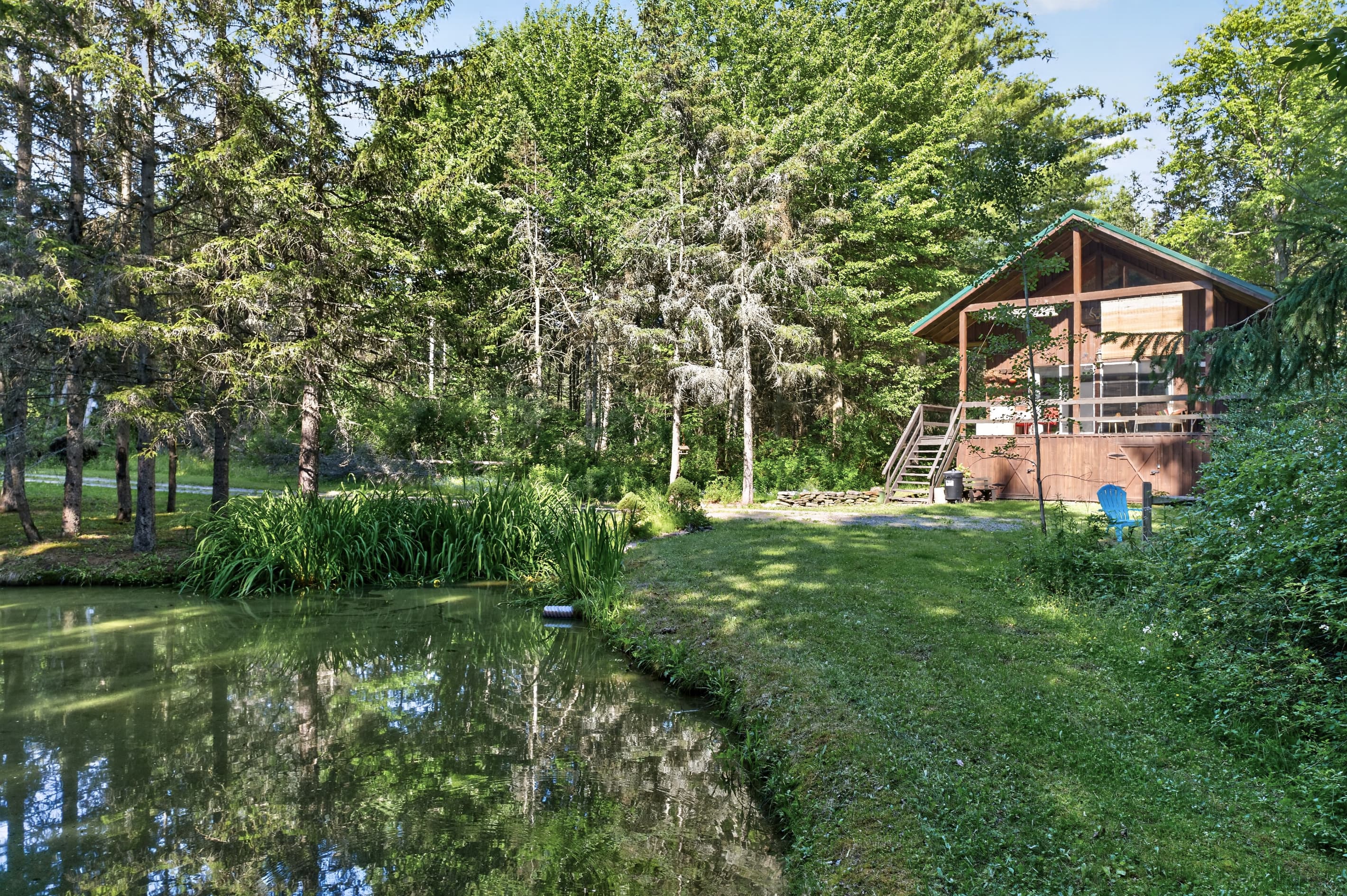 Cabin exterior within the wooded and water view