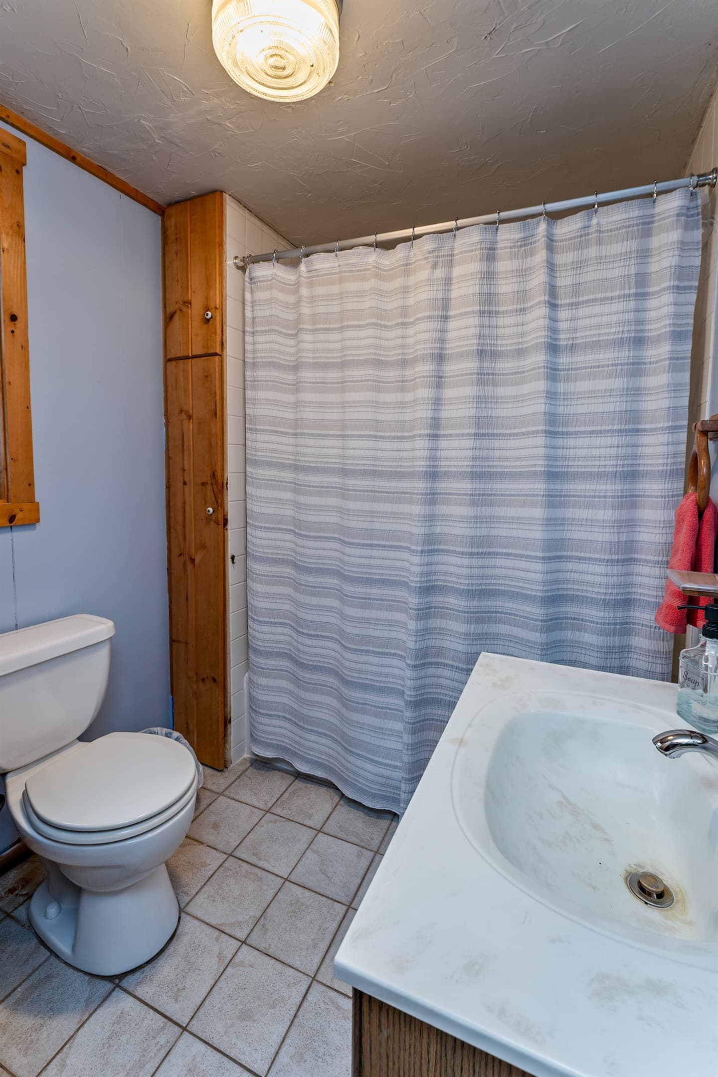 Full bathroom with marble sink and toilet