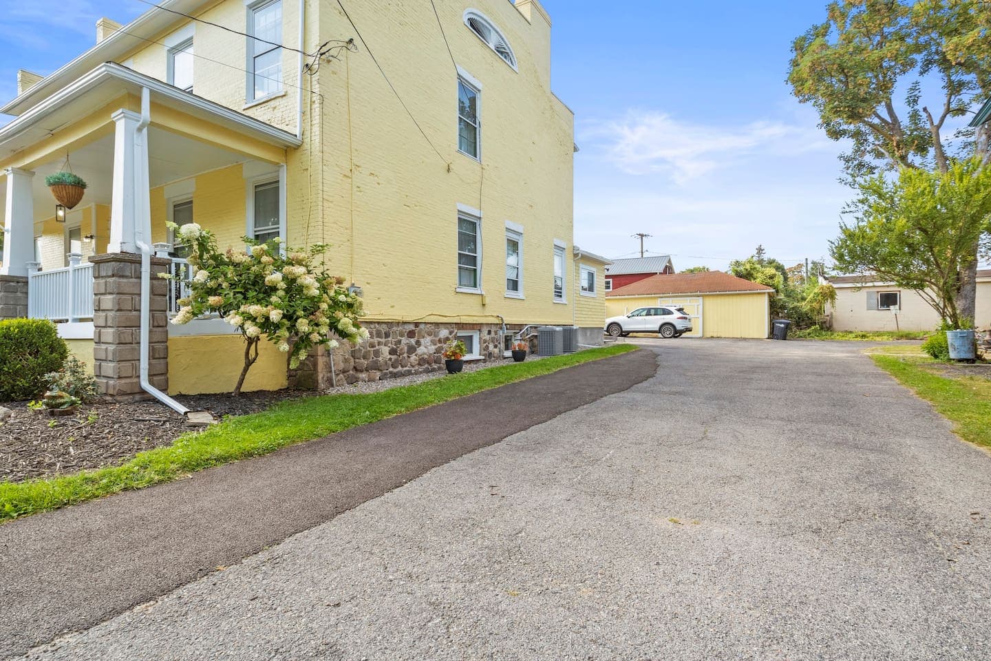 Wide driveway beside the yellow house