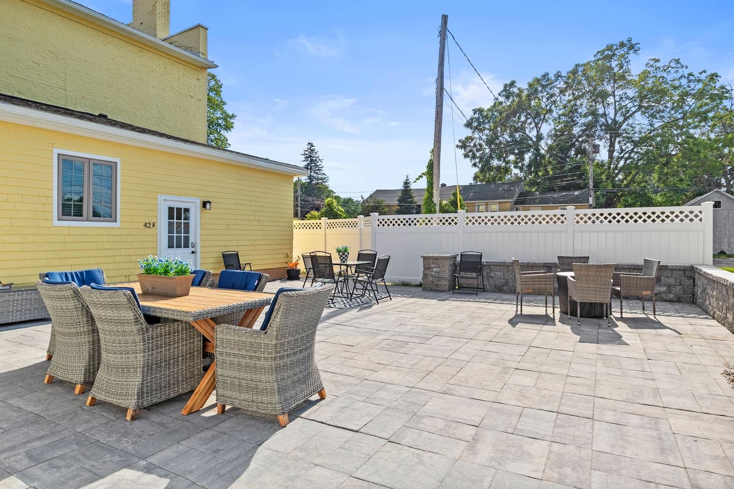 Fenced patio with several seating areas