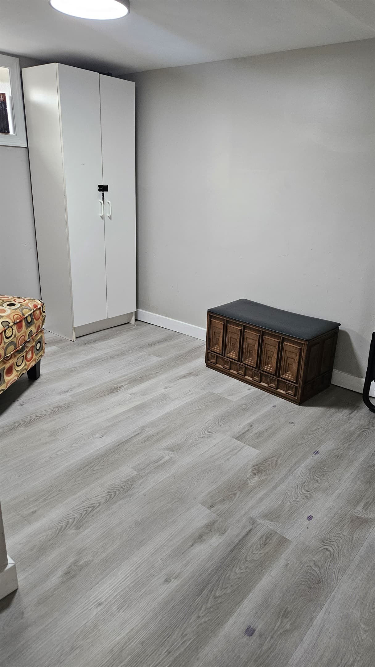 Laundry area with storage bench and closet