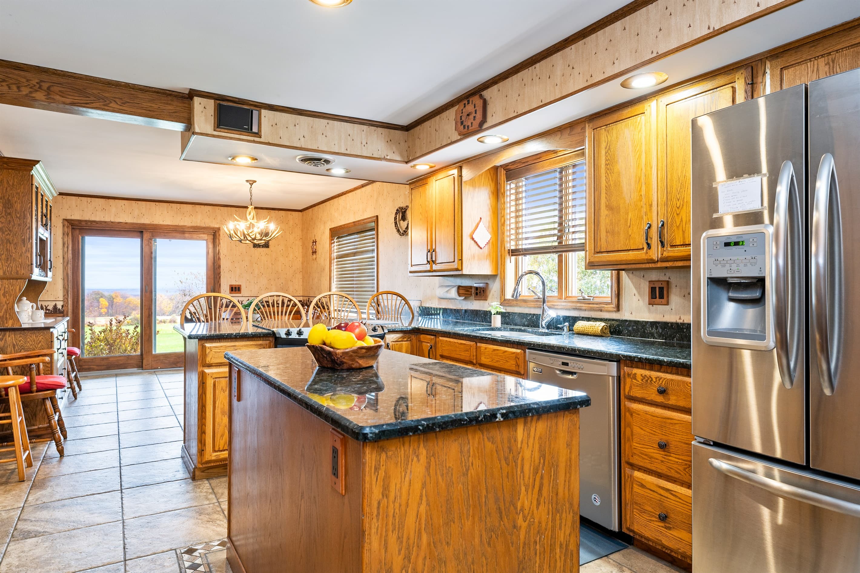 Wood kitchen with island and stainless appliances