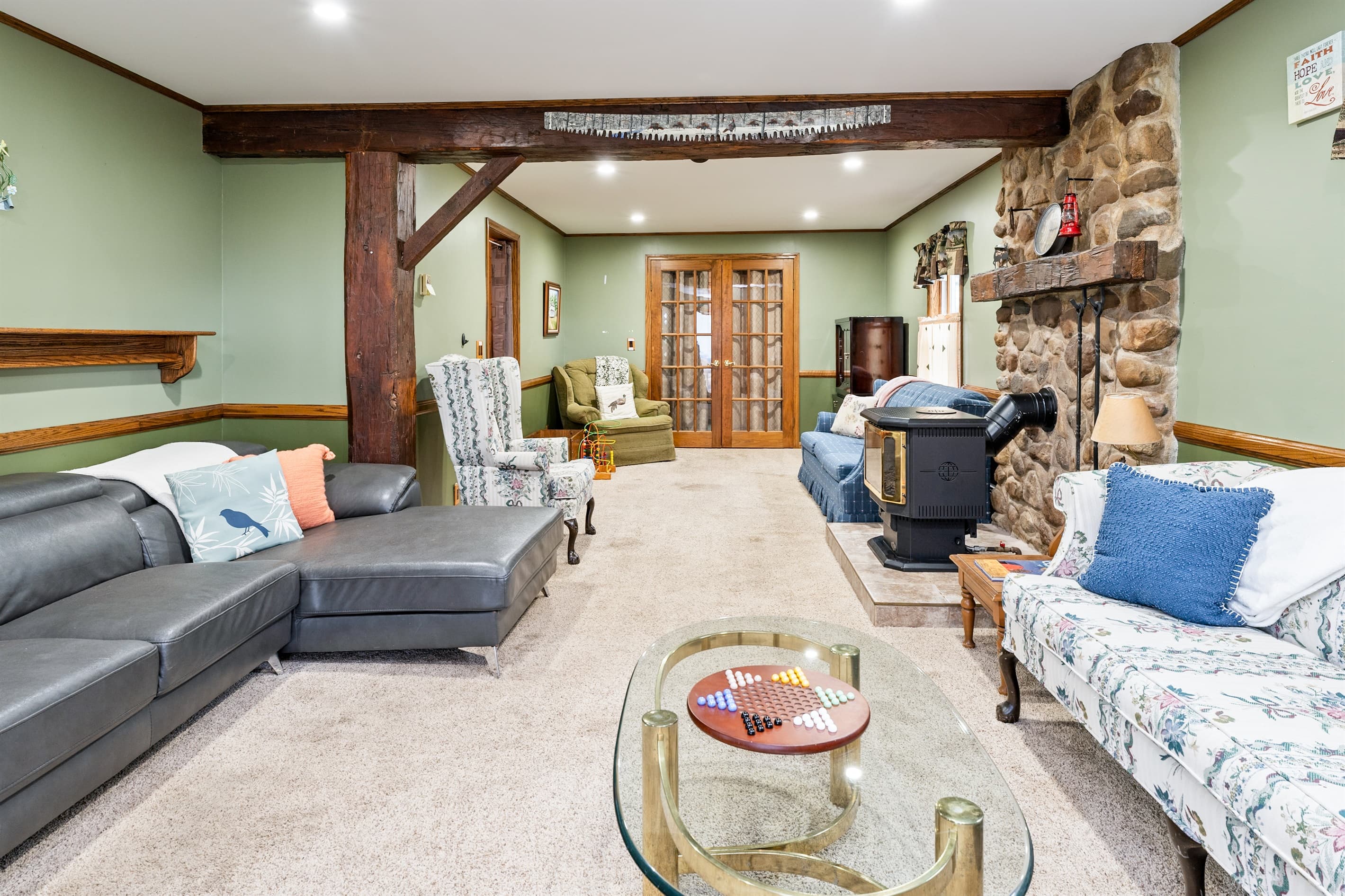 Living room with stone fireplace and sectional