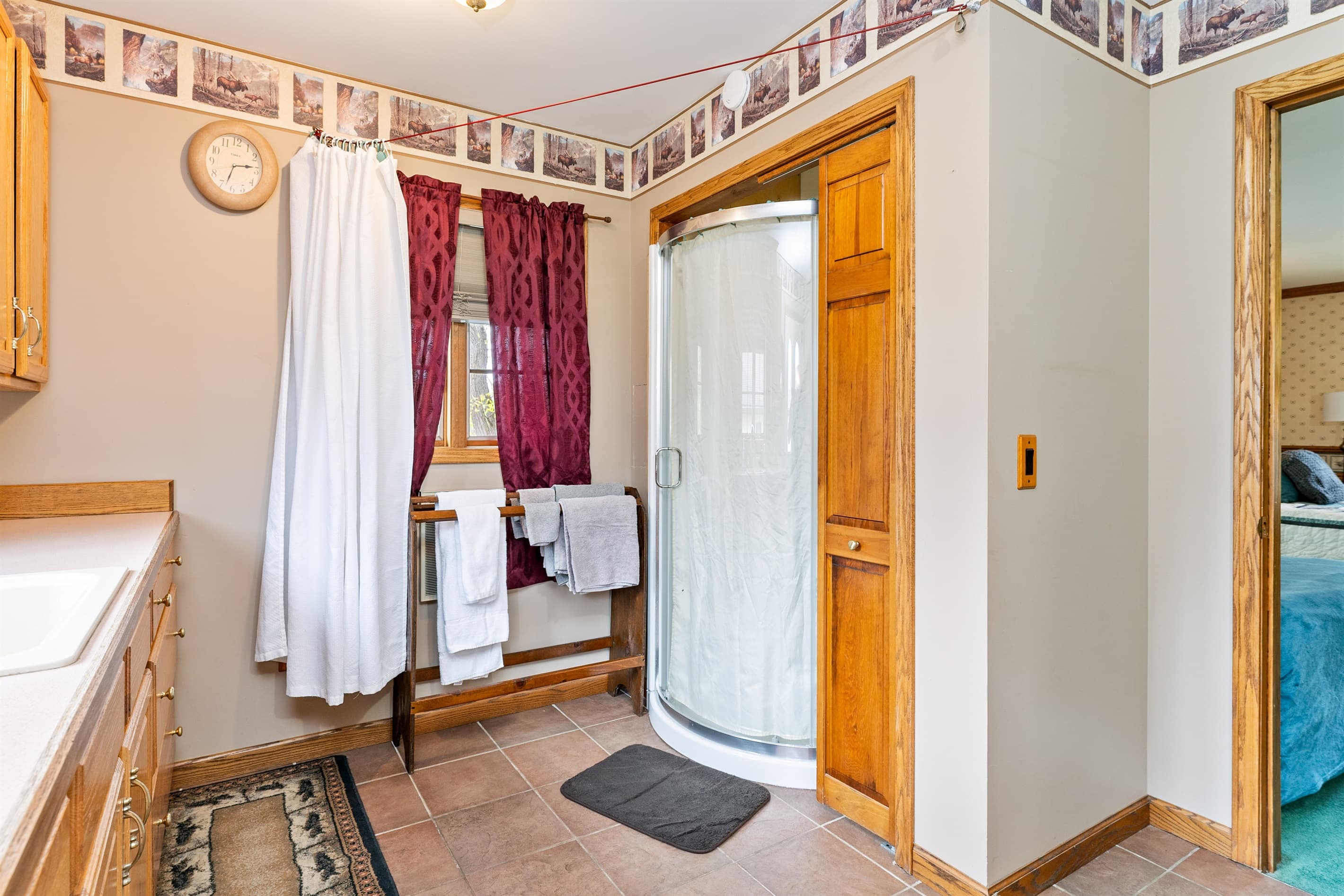 Bathroom with shower curtain and wooden door
