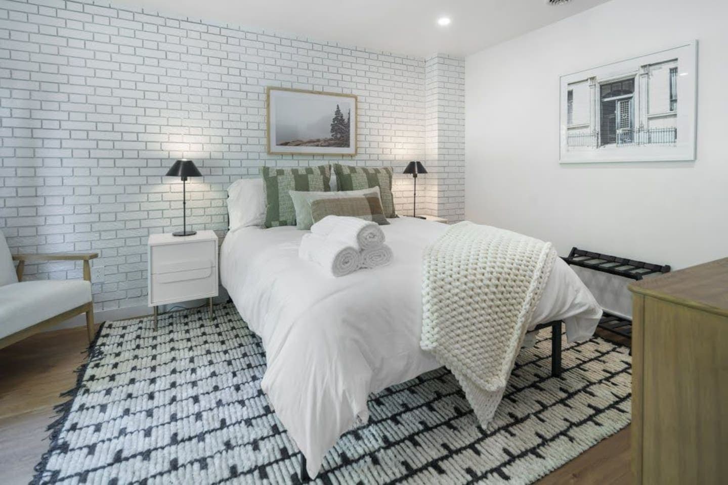 Bedroom with white brick accent wall