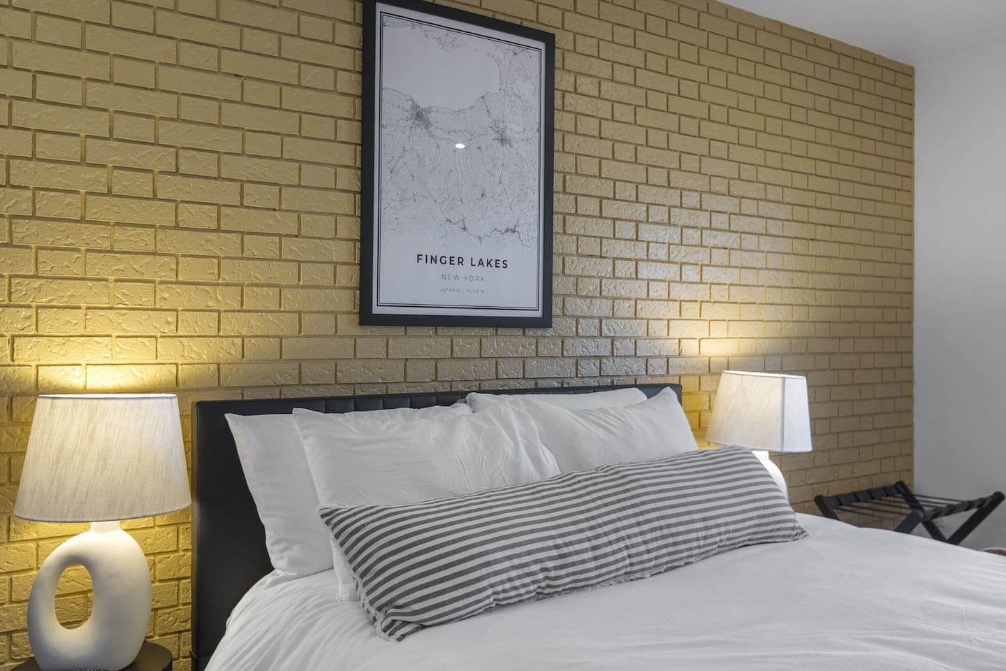 Queen bed against brick accent wall