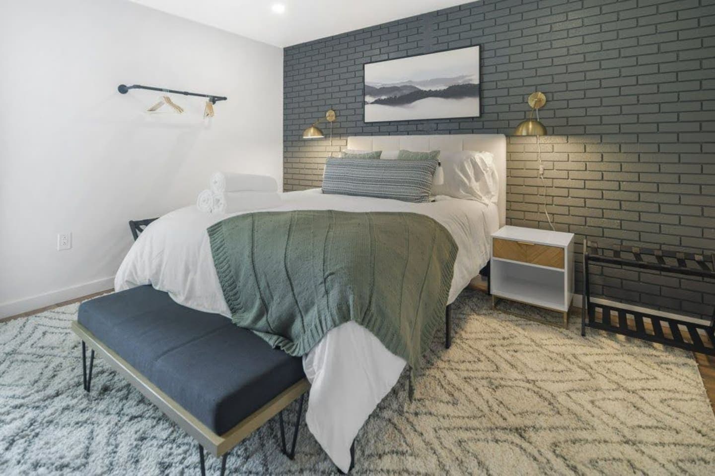 Bedroom with dark brick accent wall