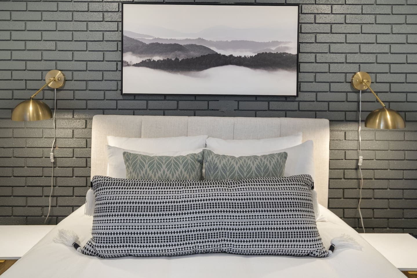 Bedside lighting against brick accent wall