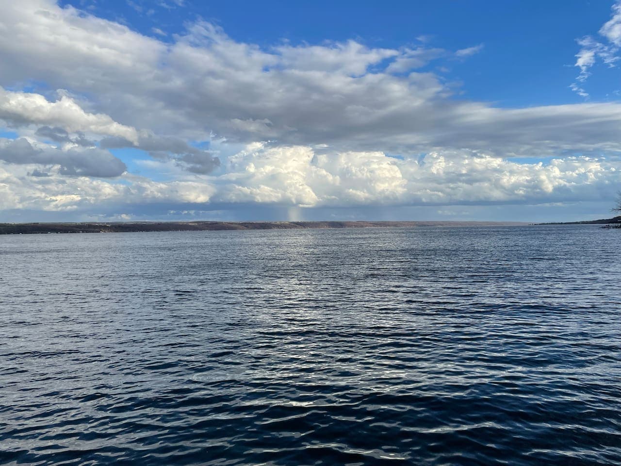 Open-water view under cloudy skies