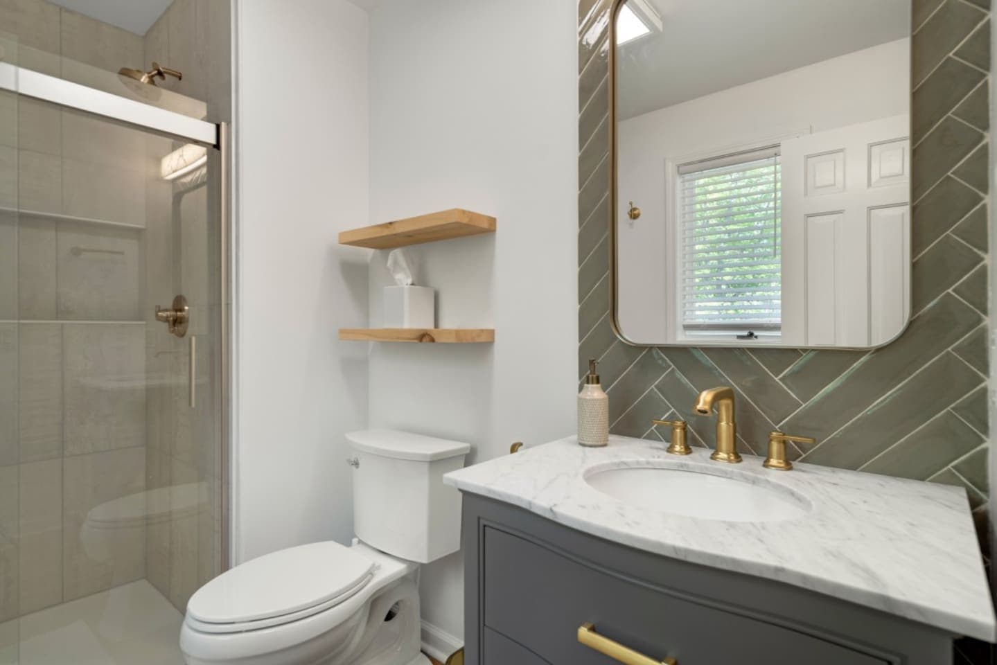 Bathroom with glass shower and green tile
