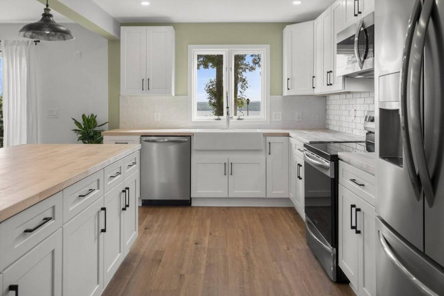 Galley kitchen with white cabinetry