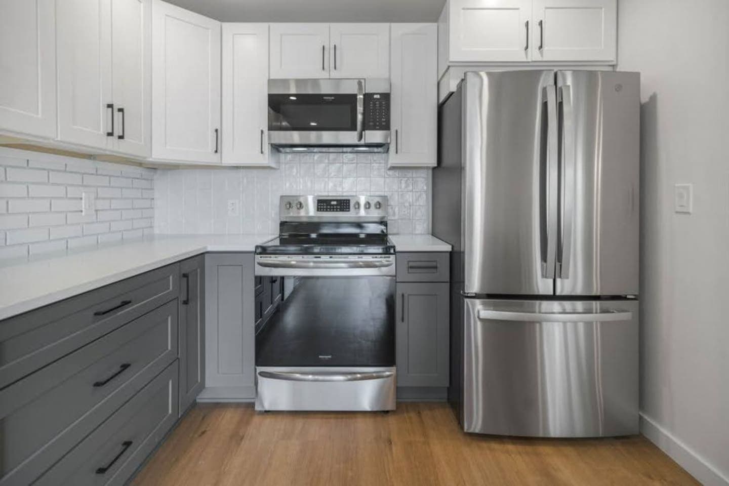 Kitchen with full-size stainless refrigerator