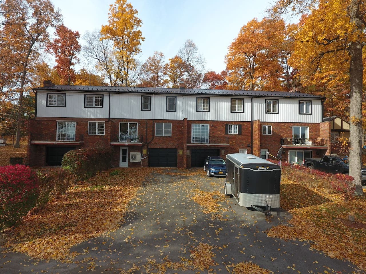 Townhome building surrounded by autumn trees