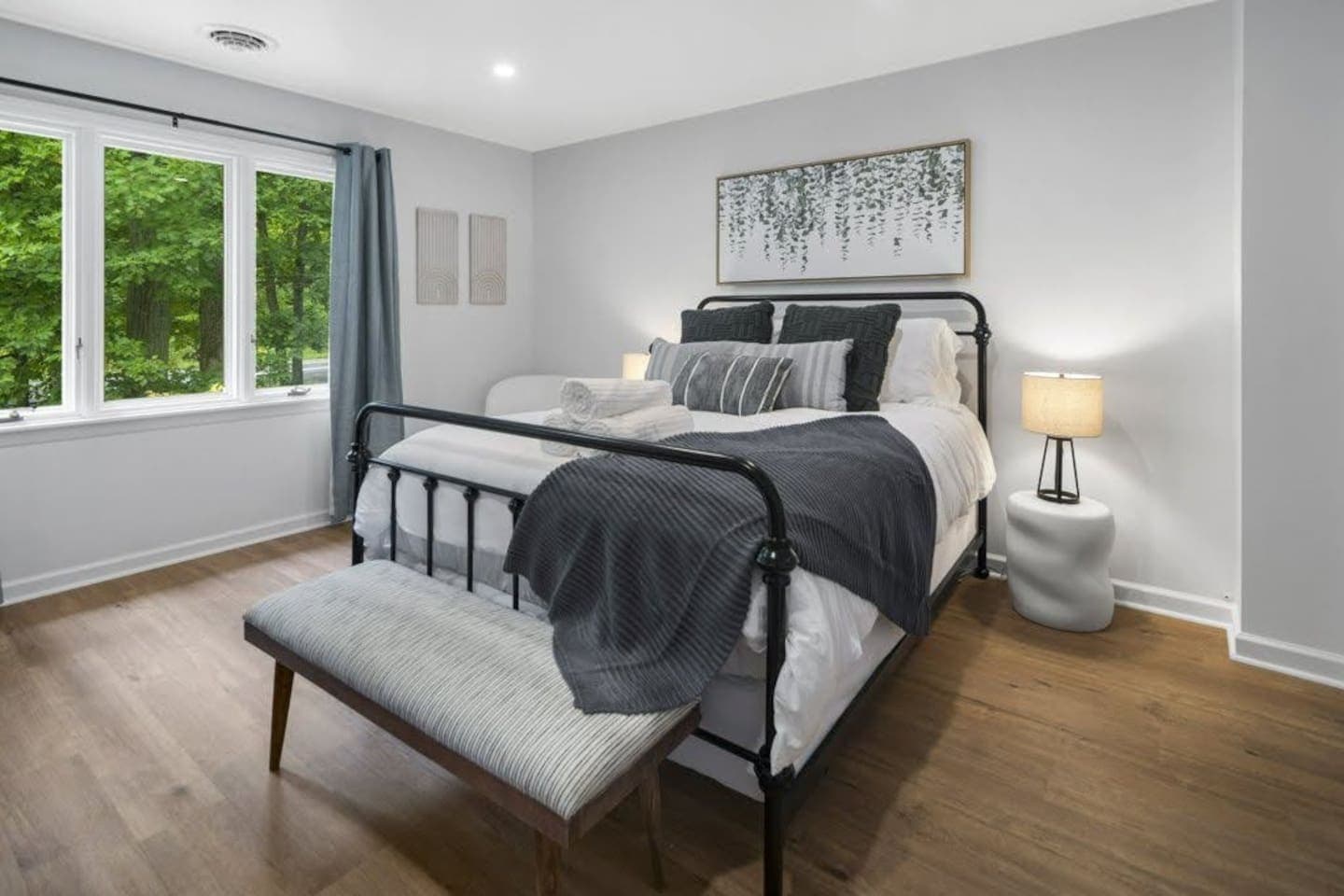 Bedroom with black bed frame and windows