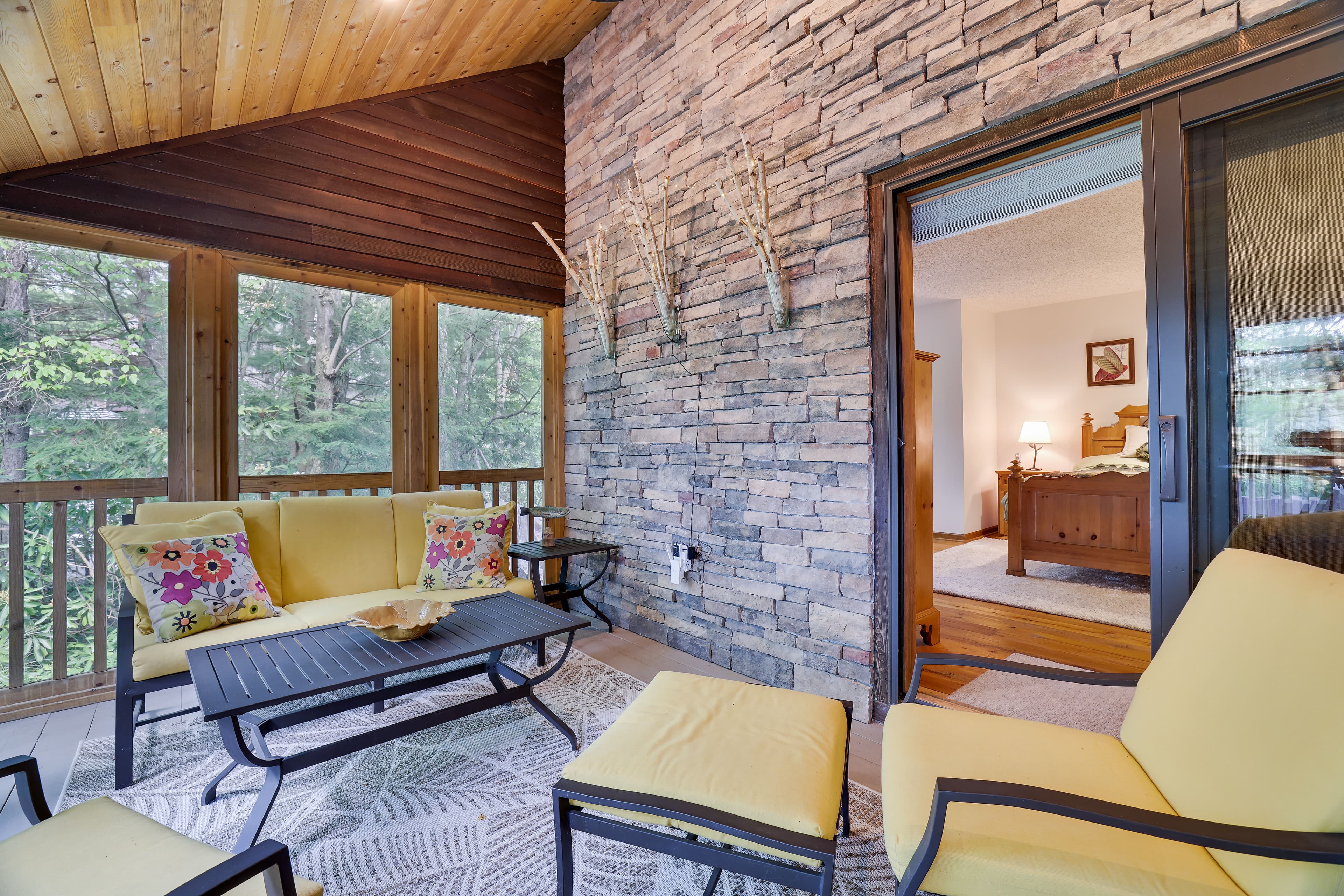 Stone and cedar screened porch facing the lake